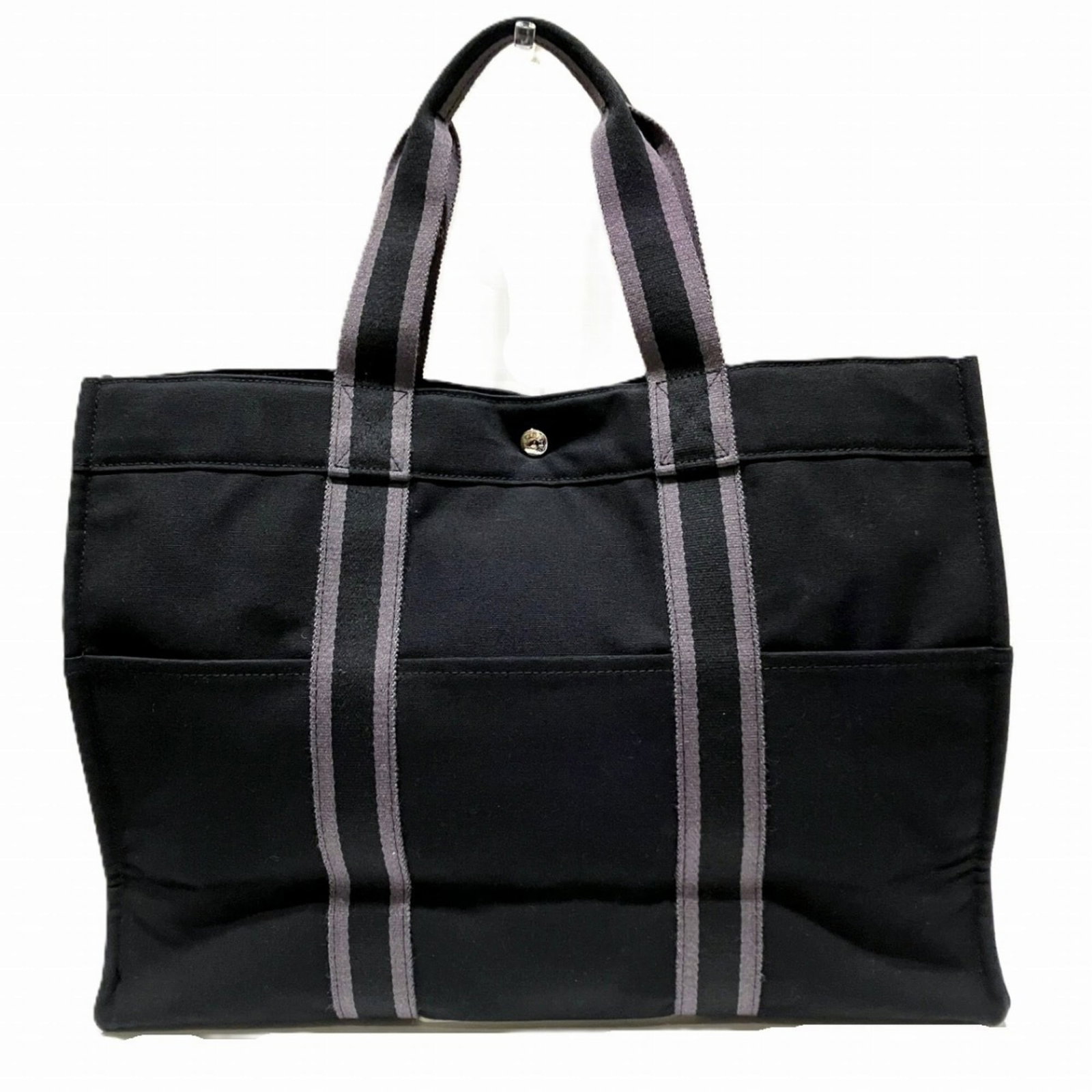 Hermes Tote Bag Canvas: Hermes Tote Bag Canvas Canvas tote bag from Hermes in black, featuring a classic design with a 34cm x 46cm x 14cm size and 42cm handle length. The item has traces of usage, scratches, and dirt, but