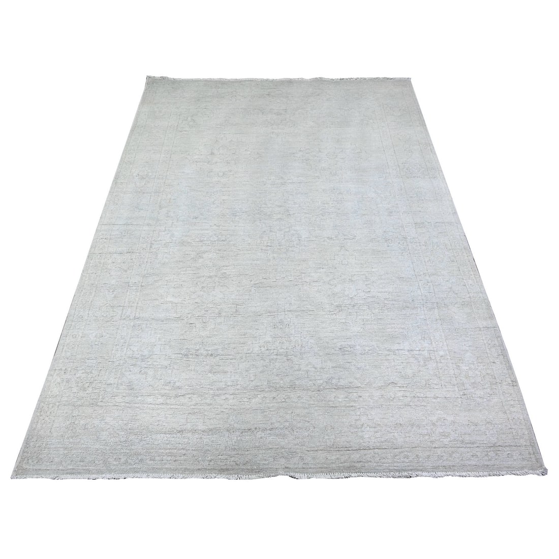 Pure wool hand knotted rug from peshawar in gray white wash.: Pure wool hand knotted rug from peshawar in gray white wash. The Peshawar hand-knotted wool rug boasts a stunning gray-white wash hue, characteristic of this traditional Afghan design. Made from high-