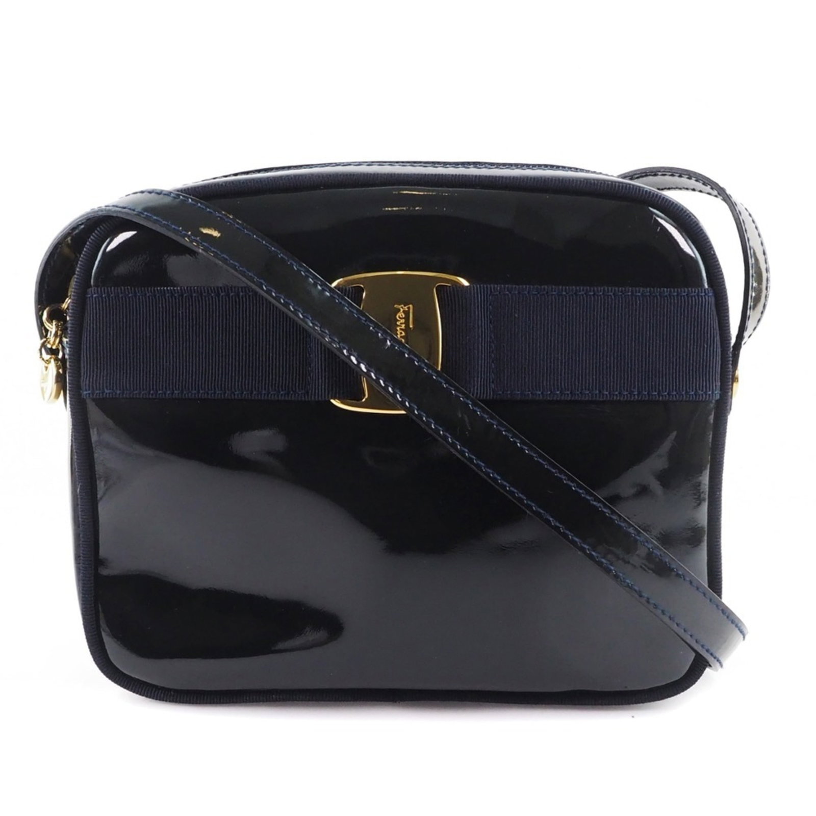 Salvatore Ferragamo Shoulder Bag Patent Leather: Salvatore Ferragamo Shoulder Bag Patent Leather The Salvatore Ferragamo Shoulder Bag features patent leather construction and a sleek black design. With its zipper closure, velcro pocket, and adjustab