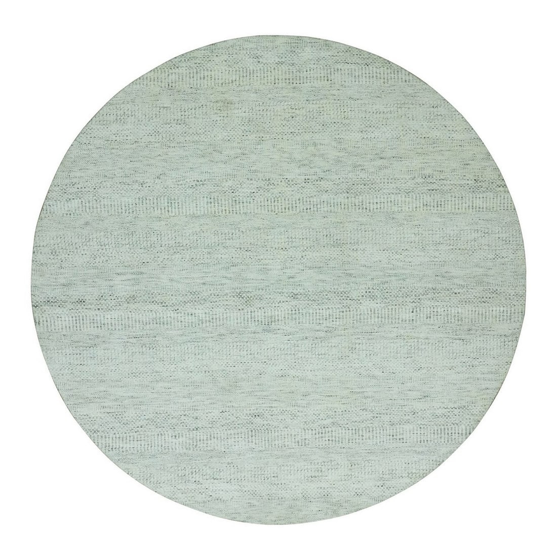 Hand knotted round rug with grass design made from 100% undyed wool.: Hand knotted round rug with grass design made from 100% undyed wool. The undyed wool rug boasts a unique grass design in a soft grey hue, adding a touch of natural elegance to any indoor space. Hand k