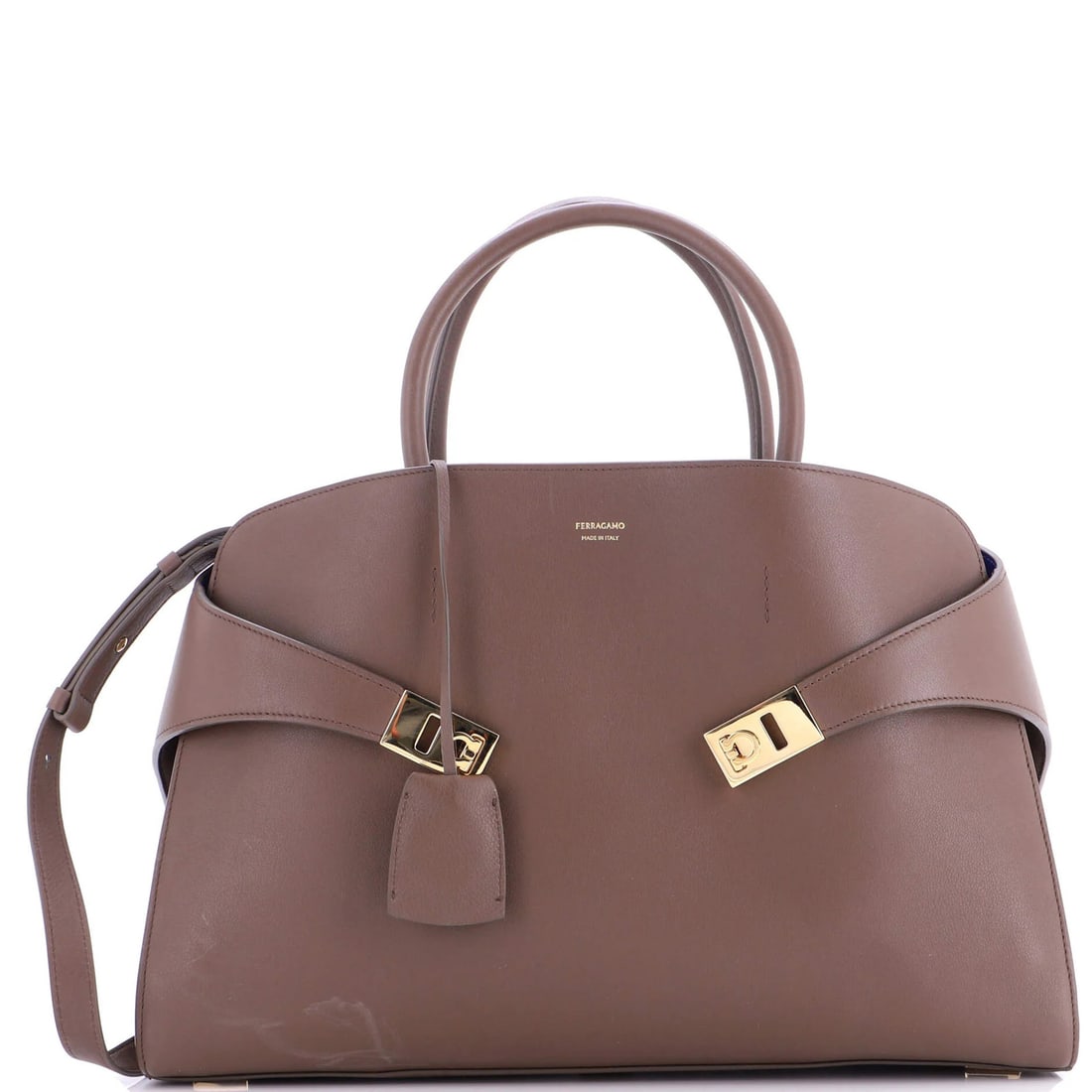 Leather Large Top Hug Bag Ferragamo Salvatore: Leather Large Top Hug Bag Ferragamo Salvatore The Salvatore Ferragamo Leather Large Top Hug Bag boasts a classic design with a rich brown exterior and contrasting blue interior. With its spacious dime