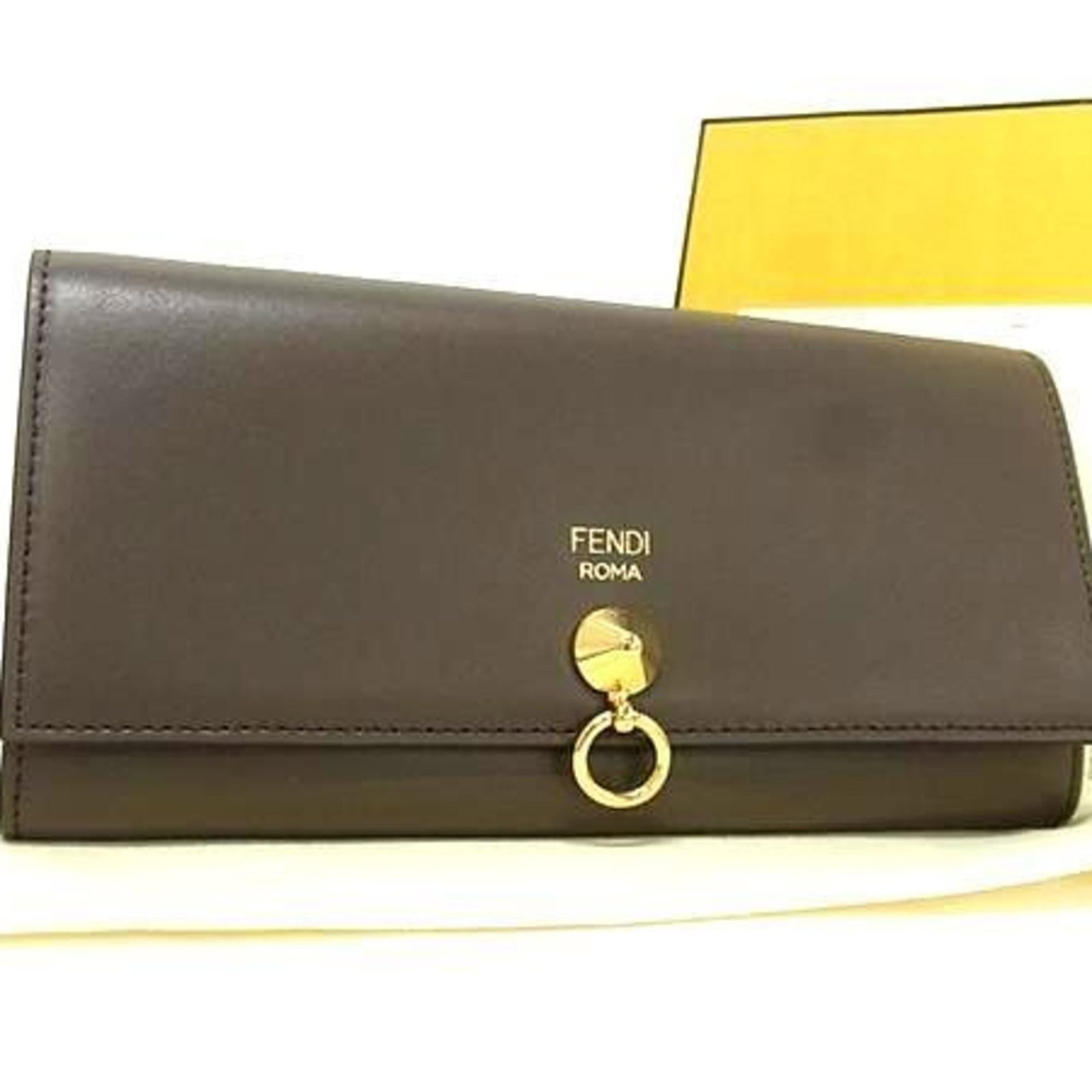 Fendi Long Wallet (Bi-Fold) Leather: Fendi Long Wallet (Bi-Fold) Leather The Fendi Long Wallet (Bi-Fold) Leather is a stylish and functional accessory, featuring a sleek grayish color and bi-fold design. Made from high-quality leather,