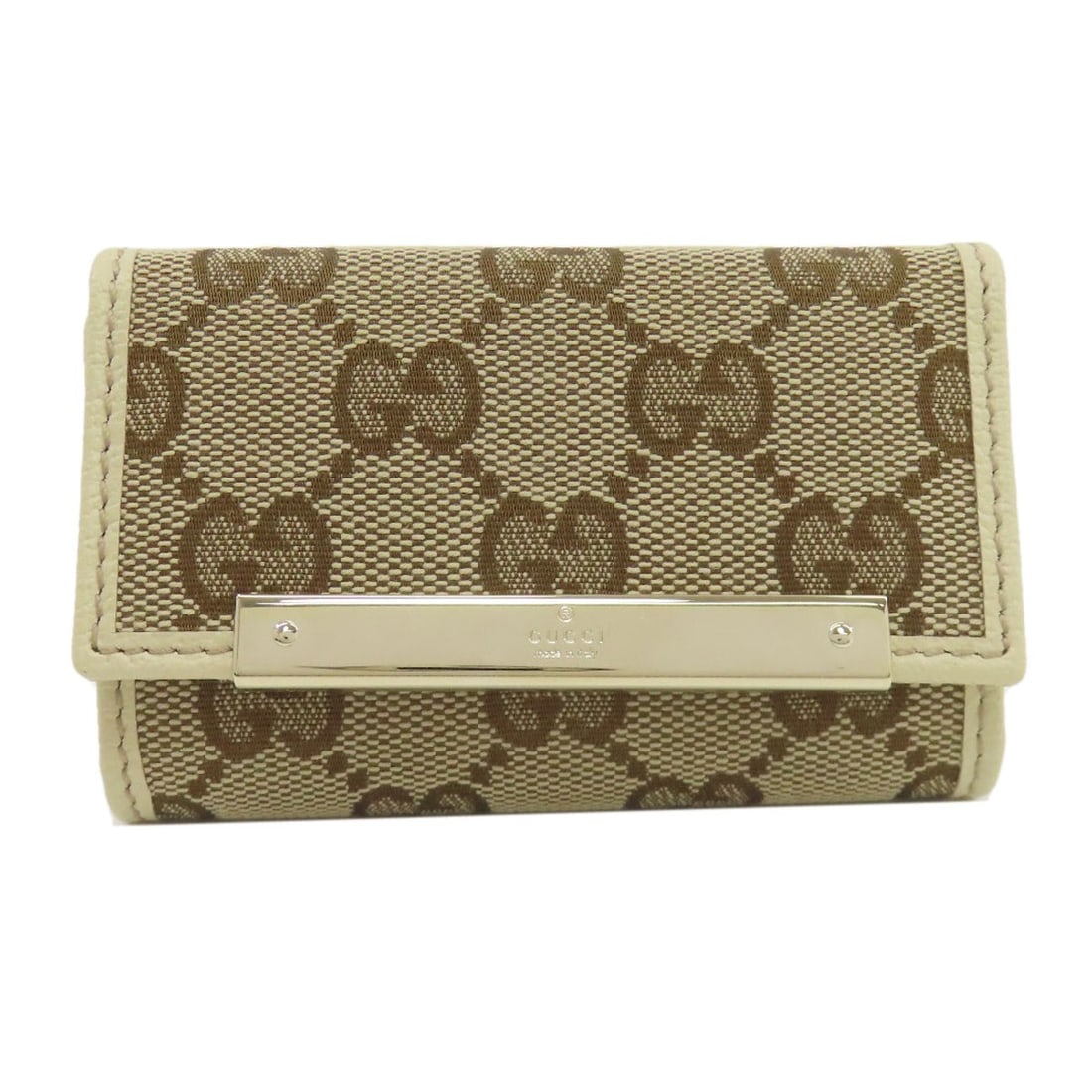 Canvas leather key holder: Canvas leather key holder Canvas leather key holder from GUCCI in brown. This stylish accessory features canvas material and a brown exterior color, making it a versatile addition to any bag or