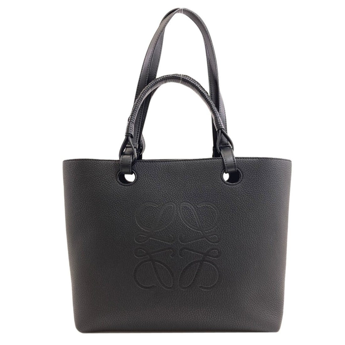 Calf bag tote an Loewe: Calf bag tote an Loewe Calf bag tote from LOEWE in black. This stylish tote features calf exterior material and is designed as a classic tote bag. Made with high-quality materials, its sleek design ma