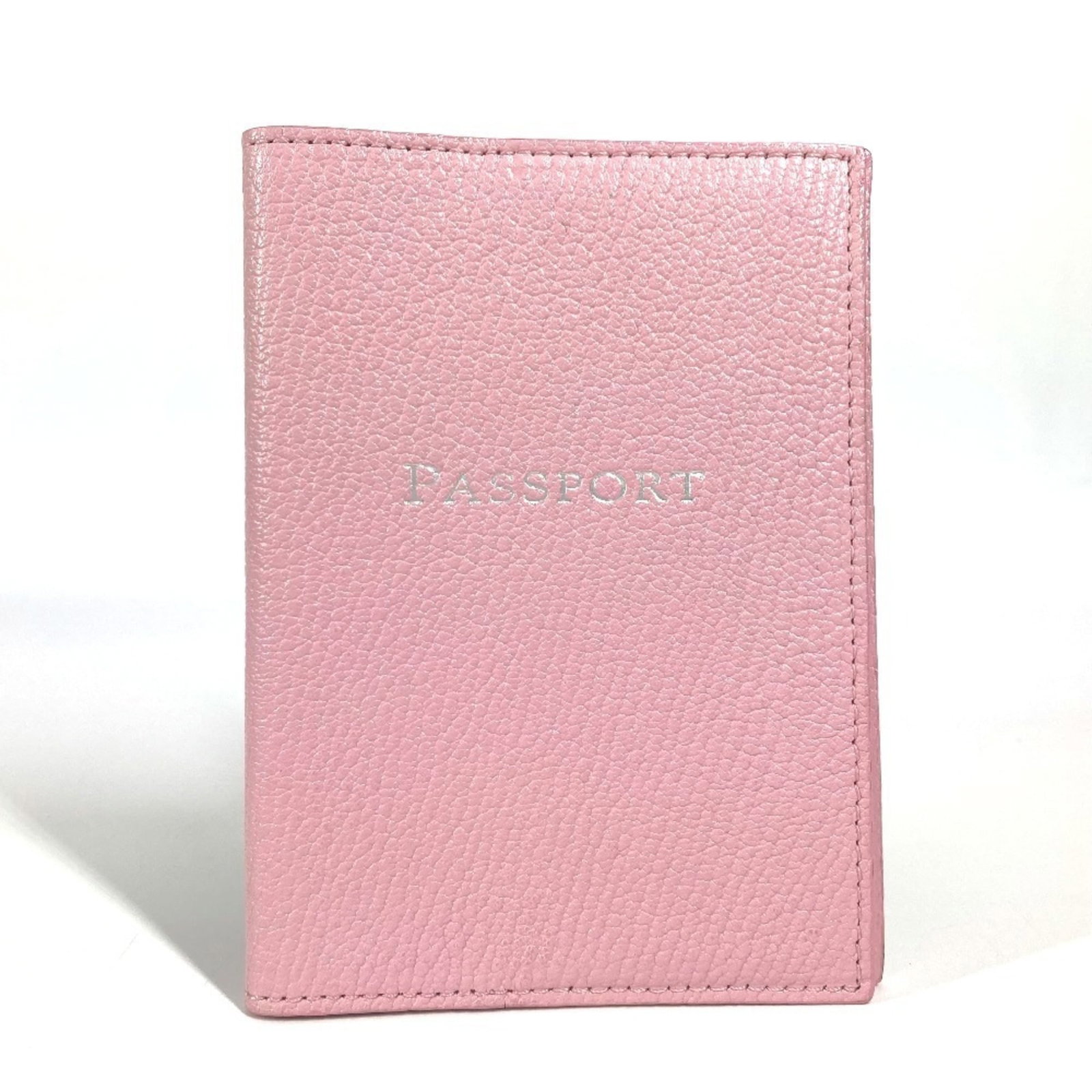 Tiffany Passport Cover Leather: Tiffany Passport Cover Leather This used Tiffany Passport Cover Leather features a pink leather exterior with some scratches and dirt, giving it a worn-in look. The material is made of high-quality le