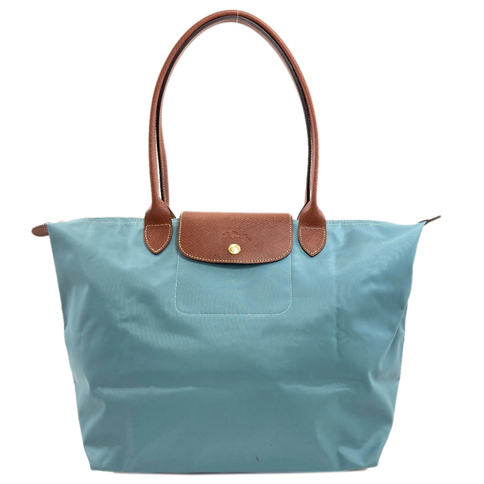 Longchamp Tote Bag Nylon: Longchamp Tote Bag Nylon Light blue Longchamp tote bag made from durable nylon, featuring an open pocket and snap fastener closure. The bag has some minor scratches and dirt, but remains in very good