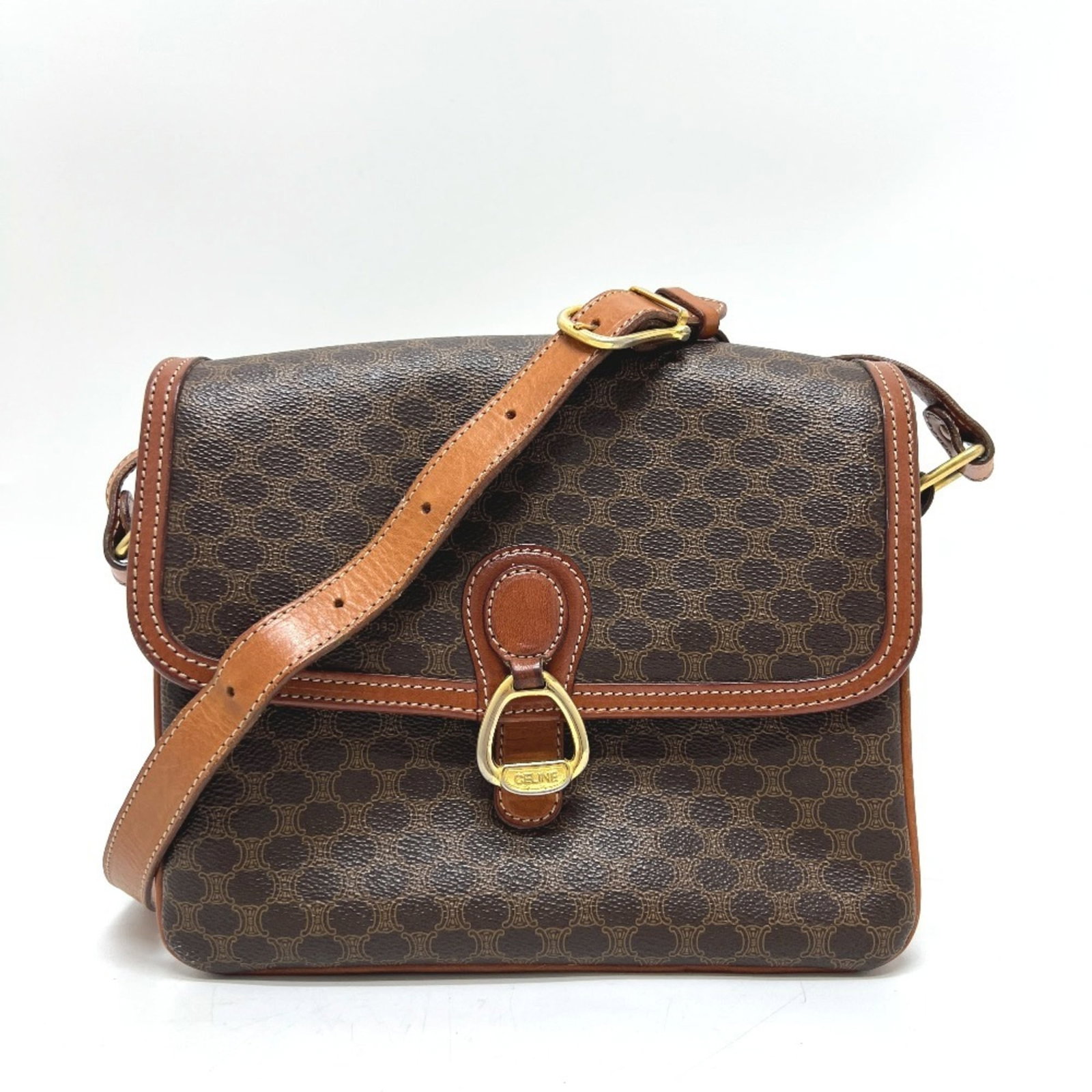 Celine Shoulder Bag Pvc Leather: Celine Shoulder Bag Pvc Leather This Celine shoulder bag features a unique combination of Pvc and leather materials in a rich brown color. With its classic design and compact size, it's perfect for ev