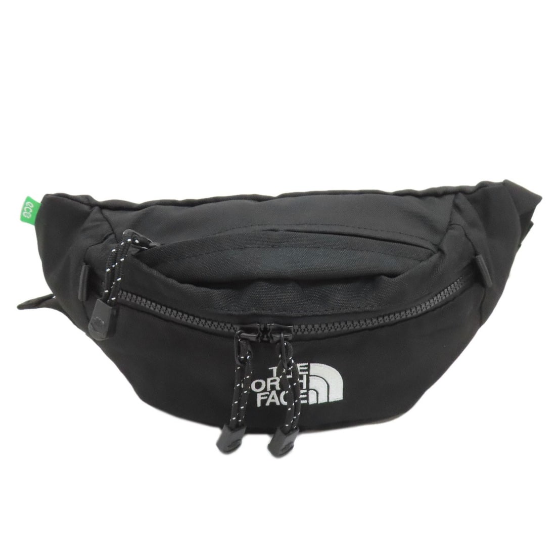 Face Logo North Hardware Body Nylon: Face Logo North Hardware Body Nylon The Face Logo North Hardware Body Nylon features a striking black exterior made from durable nylon material. A notable design element is the prominent face logo, wh
