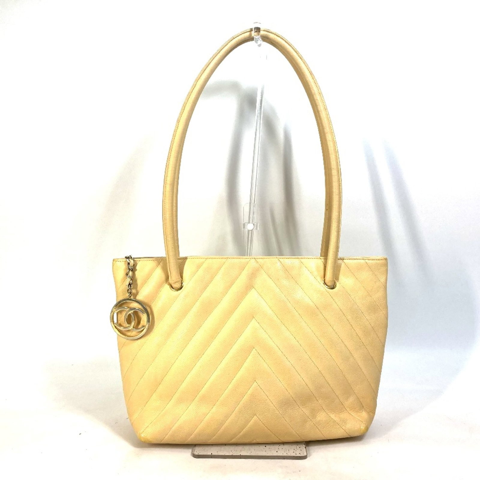 Chanel Shoulder Bag Leather: Chanel Shoulder Bag Leather This iconic Chanel shoulder bag features high-quality yellow leather and classic design elements. Measuring 29.5cm wide x 25.5cm tall x 12cm deep, it's a stylish accessory 