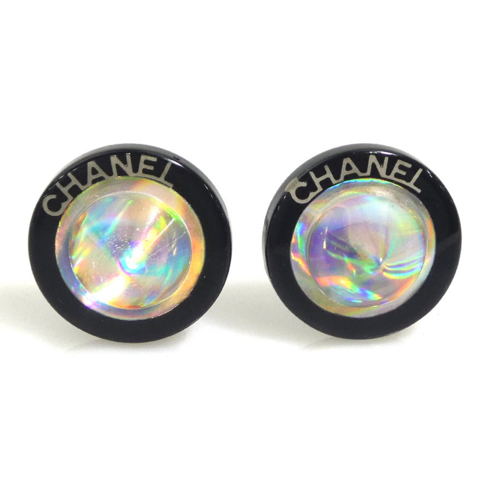 Chanel Clip Earrings Metal Resin: Chanel Clip Earrings Metal Resin Metal and resin construction gives these Chanel clip earrings a sleek, modern look. The black finish has some traces of usage, with minor scratches and dirt visible,