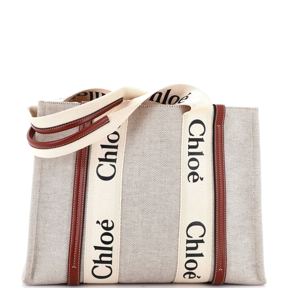 Canvas tote bag with leather medium: Canvas tote bag with leather medium Canvas tote bag with leather medium features a sturdy brown canvas exterior and a sleek leather trim. The bag's neutral interior provides ample space for daily esse