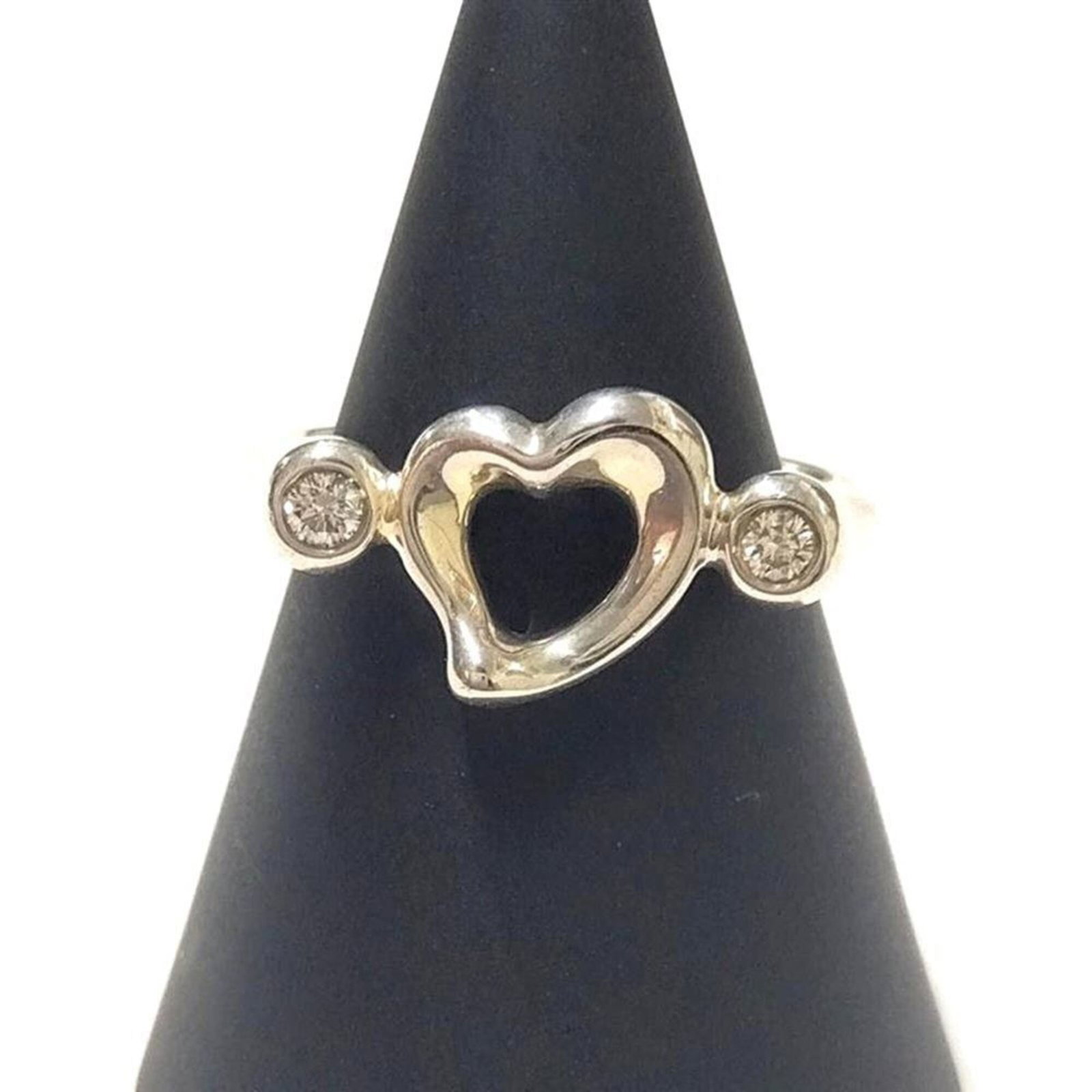 Tiffany Band Ring Silver 925: Tiffany Band Ring Silver 925 Silver Tiffany Band Ring with Diamond Stone. This used band ring features silver 925 material and a diamond stone, measuring US size 5. It shows signs of usage with minor