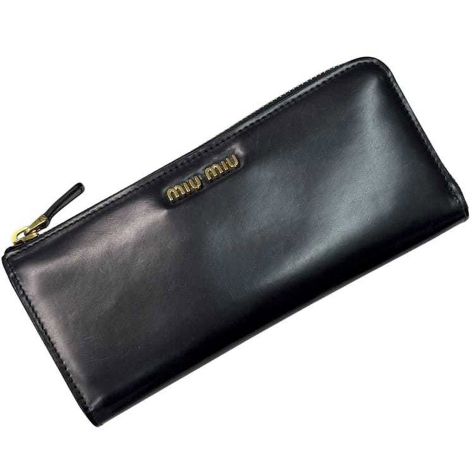 Miu Miu Coin Purse/Coin Case Leather: Miu Miu Coin Purse/Coin Case Leather The Miu Miu Coin Purse/Coin Case Leather is a sleek and sophisticated accessory made from high-quality leather. With its classic design and timeless black color,