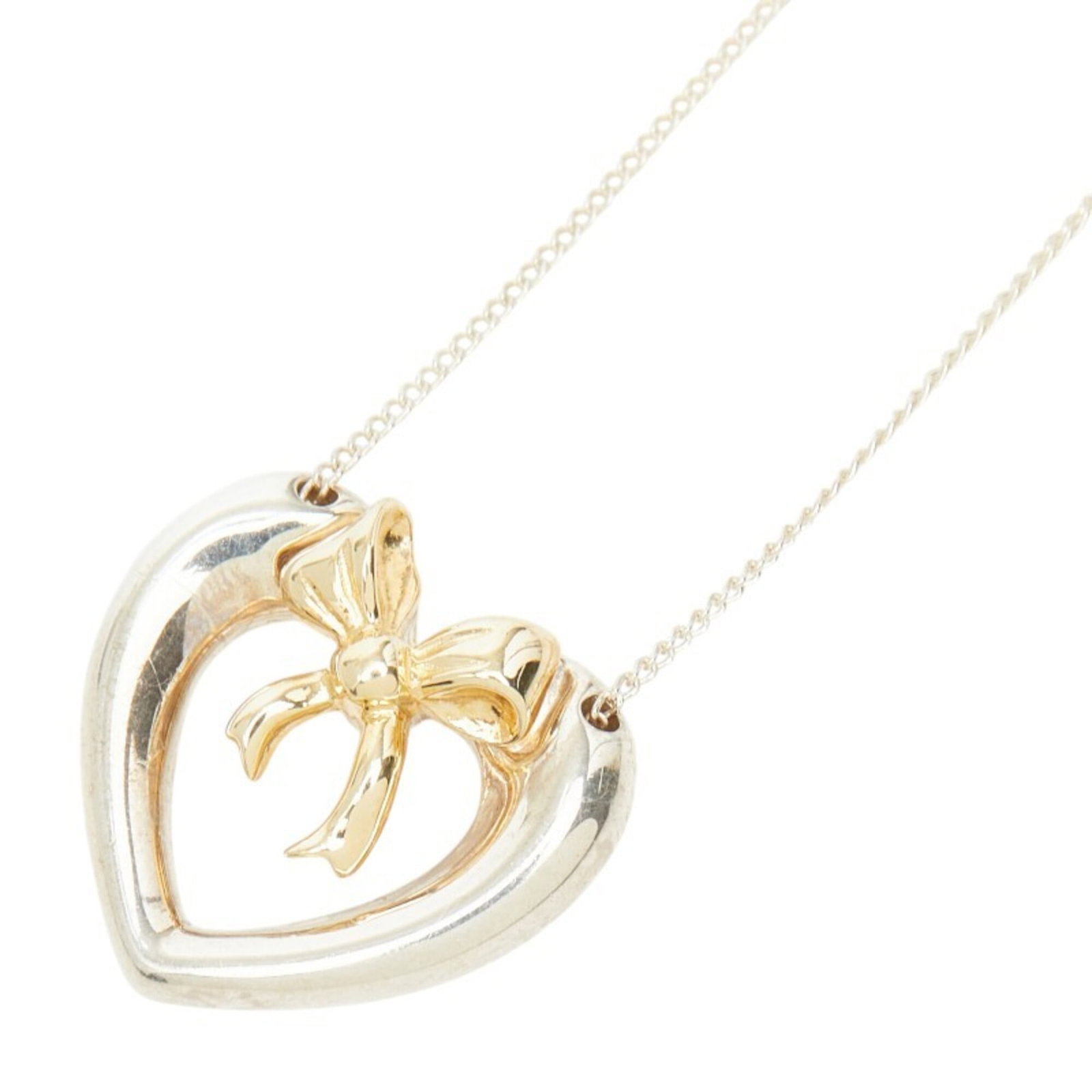 Tiffany & Co. Heart Ribbon Necklace Sv925 Sterling Silver 18K Yellow Gold Women'S.: Tiffany & Co. Heart Ribbon Necklace Sv925 Sterling Silver 18K Yellow Gold Women'S. Tiffany & Co. Heart Ribbon Necklace in sterling silver and 18K yellow gold boasts a classic design with intricate det