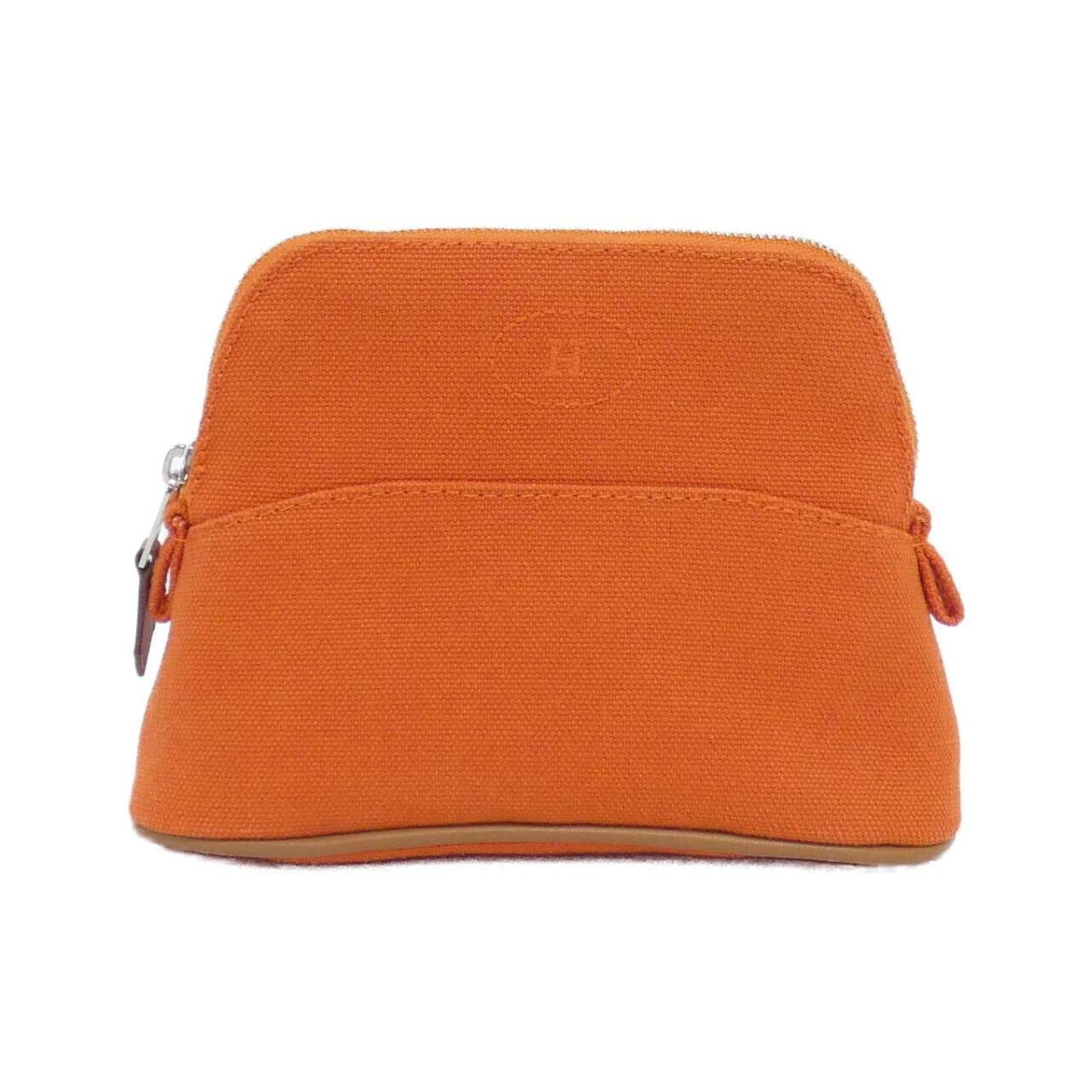 Hermes Pouch Canvas: Hermes Pouch Canvas The Hermes Pouch Canvas is a vibrant orange canvas pouch with silver hardware, bearing a few traces of usage and minor scratches. Its compact size makes it easy to carry,