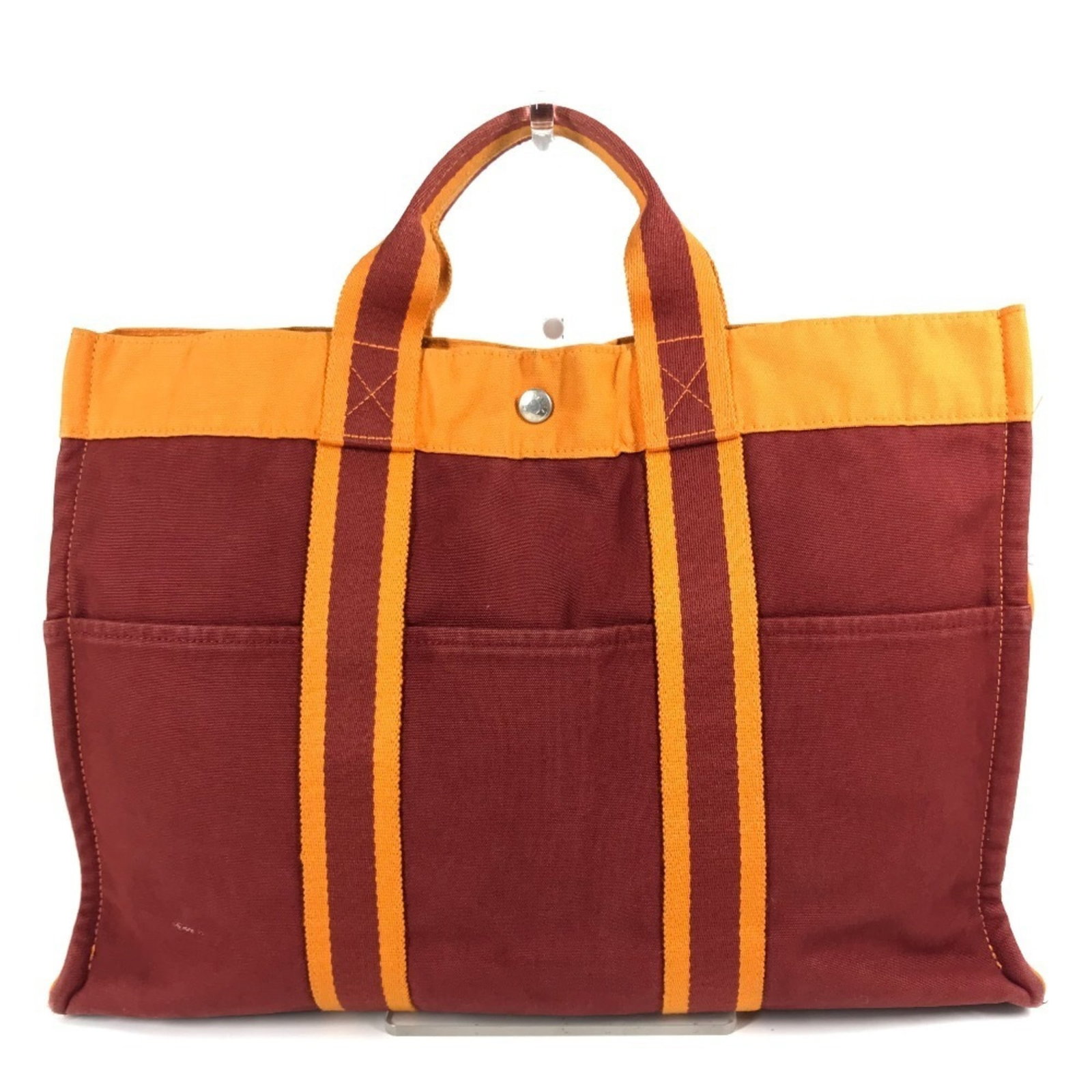Hermes Handbag Tote Bag Cotton: Hermes Handbag Tote Bag Cotton Orange and Red Cotton Tote Bag from Hermes. This vibrant tote bag features a unique cotton material and measures 30cm x 41.5cm x 10cm. With traces of usage and minor scr