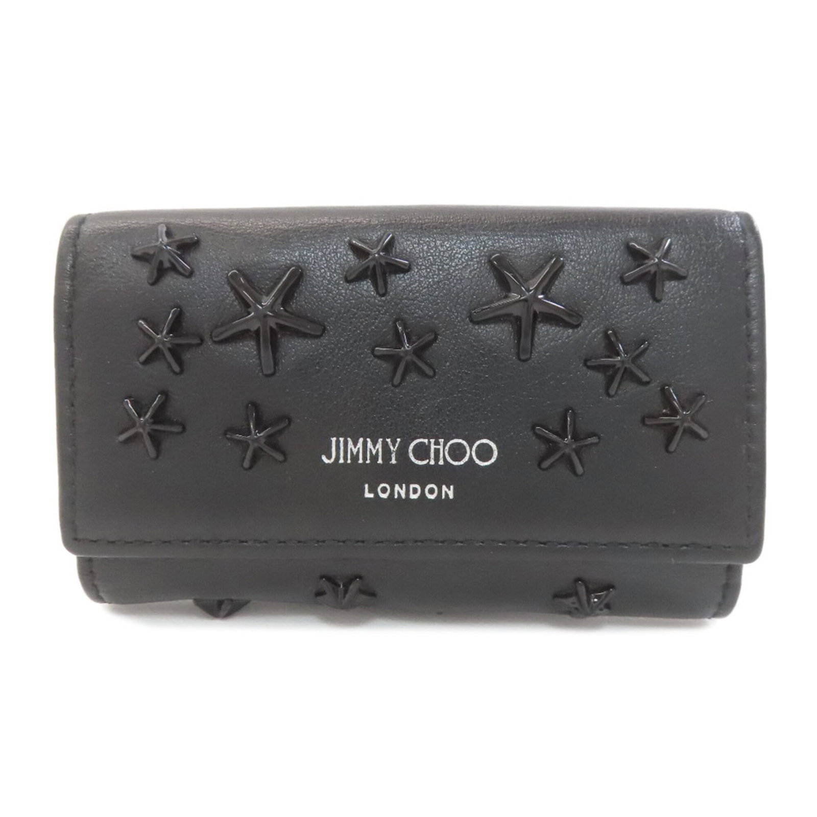 Jimmy Choo Keycase Leather: Jimmy Choo Keycase Leather Used Jimmy Choo Keycase Leather in black with six key hooks and an open pocket. The leather has some scratches and dirt, but overall remains in very good condition with a