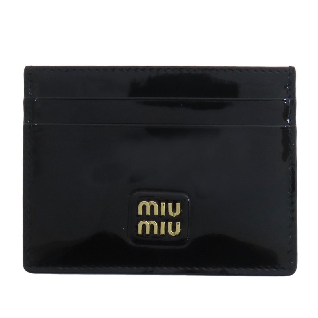 Miu logo card case leather: Miu logo card case leather The Miu logo card case leather is a sleek and sophisticated accessory made from high-quality black leather. The classic design features a prominent MIUMIU logo on the exteri