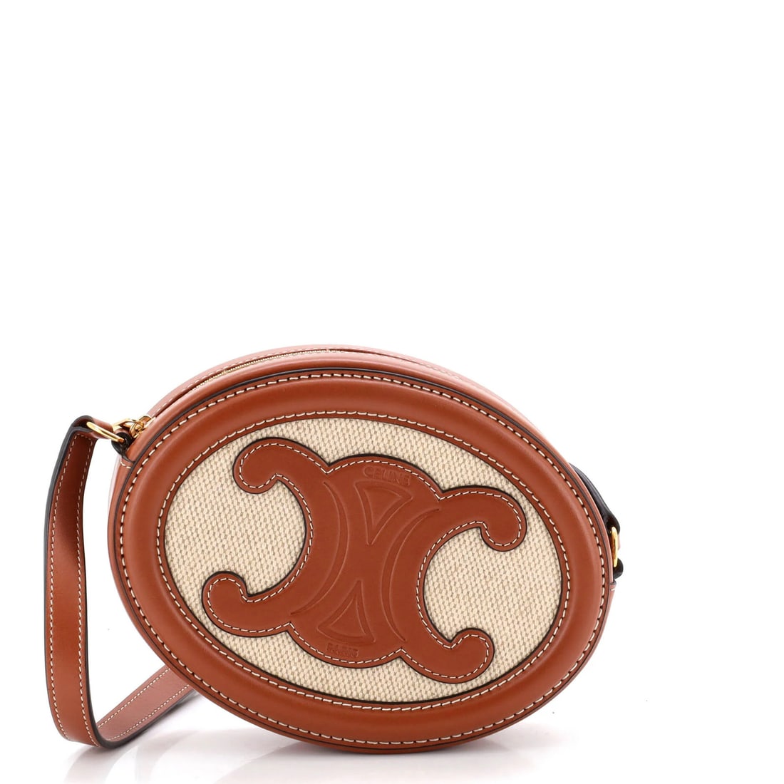 Canvas leather oval crossbody bag triomphe celine: Canvas leather oval crossbody bag triomphe celine The Celine Triomphe Oval Crossbody Bag boasts a striking canvas and leather exterior in rich brown tones. With its classic oval shape and gold hardwar