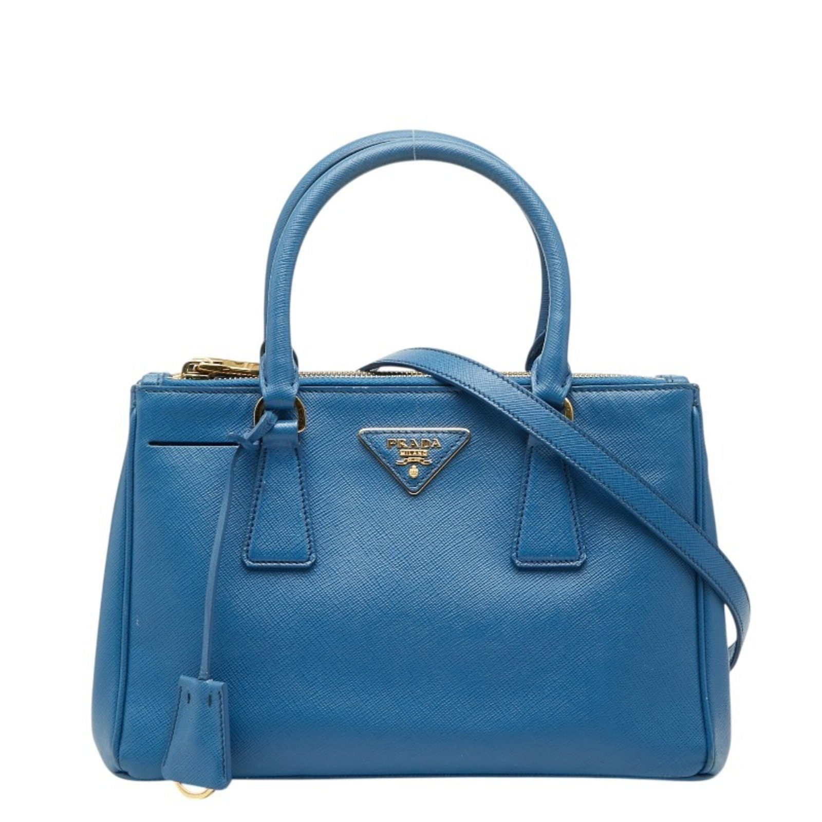 Prada Shoulder Bag Leather: Prada Shoulder Bag Leather Saffiano leather shoulder bag in blue, featuring an open closure and adjustable strap. Measuring 18cm x 25cm x 10cm, this Prada bag has a handle drop of 10cm and a strap dro