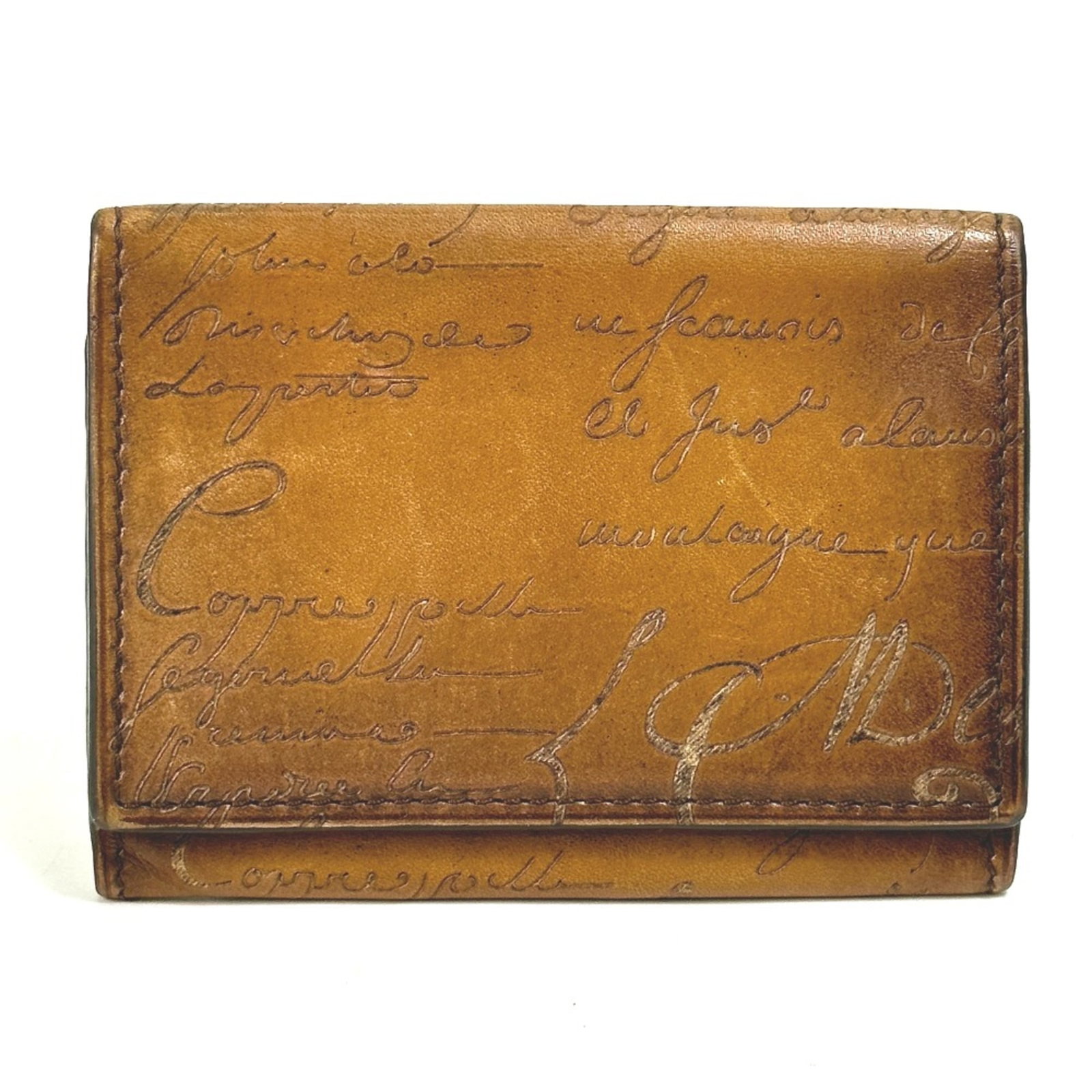 Berluti Card Case Leather: Berluti Card Case Leather Berluti Card Case Leather in Brown. This used card case features high-quality leather with visible scratches and dirt, giving it a worn-in look. Its compact size makes it ide