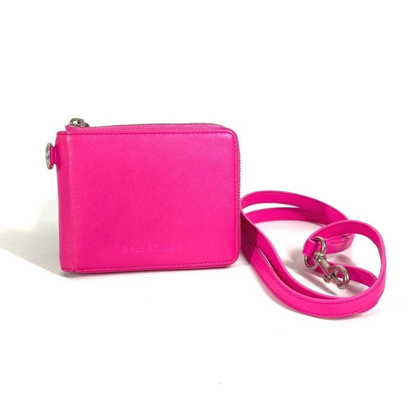 Balenciaga Wallet (Bi-Fold) Leather: Balenciaga Wallet (Bi-Fold) Leather The Balenciaga wallet features a sleek bi-fold design made from high-quality leather. With its vibrant pink color and compact size, this wallet is perfect for every