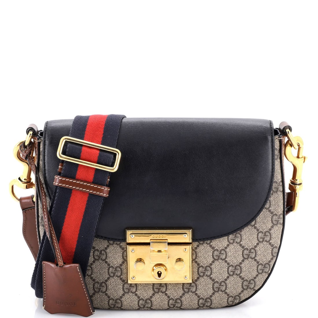 Medium leather coated canvas saddle shoulder bag Gucci.: Medium leather coated canvas saddle shoulder bag Gucci. Medium leather coated canvas saddle shoulder bag Gucci features heavy scuffs throughout and creases, giving it a worn-in look. The exterior is m