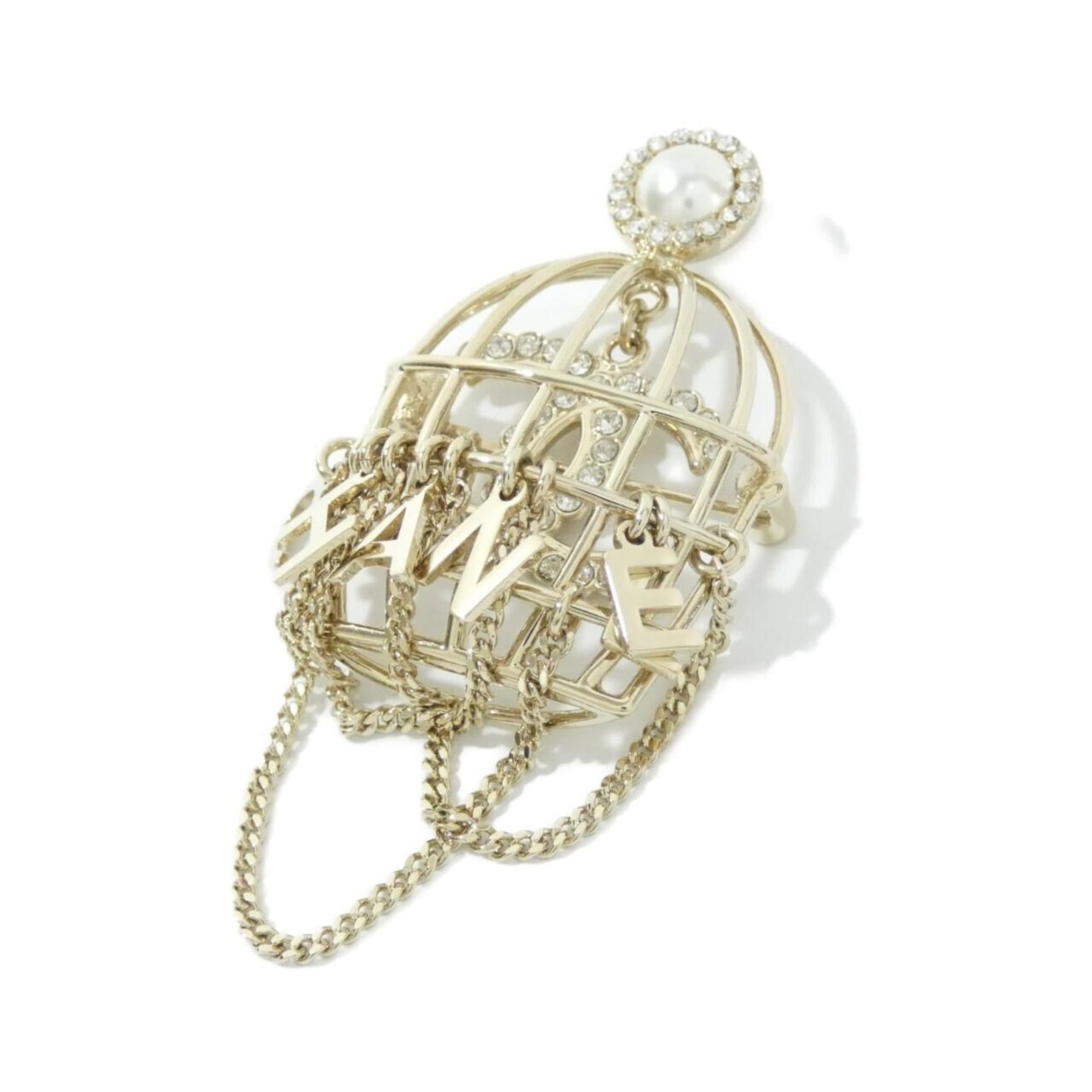 Chanel Brooch: Chanel Brooch Chanel's iconic design shines through in this gold brooch featuring an artificial pearl. With its elegant white stone and subtle scratches from years of wear, this piece has developed a 