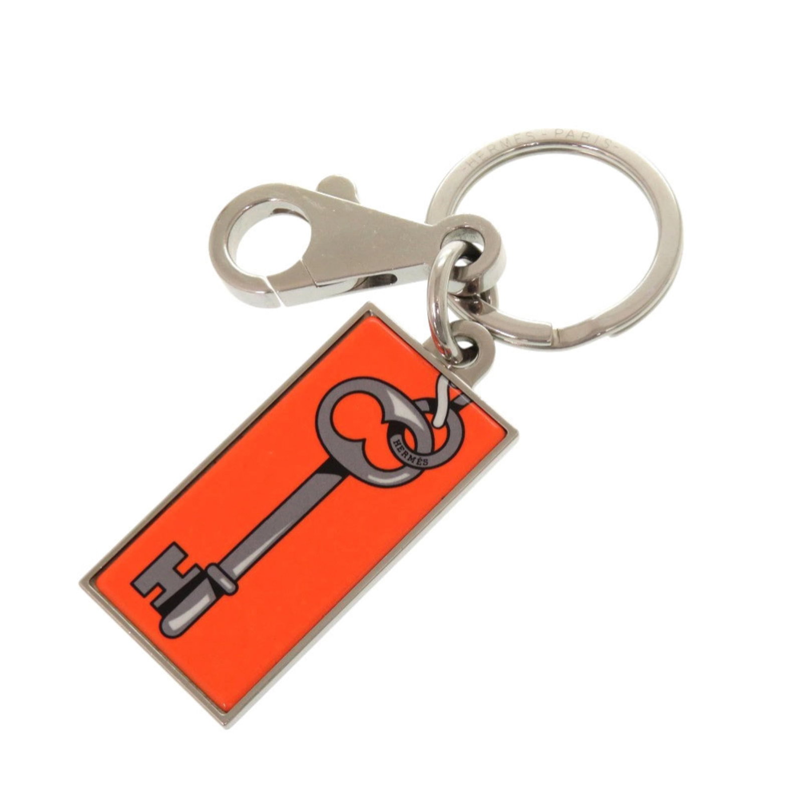 Hermes Keyring Metal: Hermes Keyring Metal The Hermes Keyring Metal boasts a vibrant orange hue and sleek metal design. With its subtle scratches and signs of usage, this keyring showcases a worn-in charm. A unique accesso