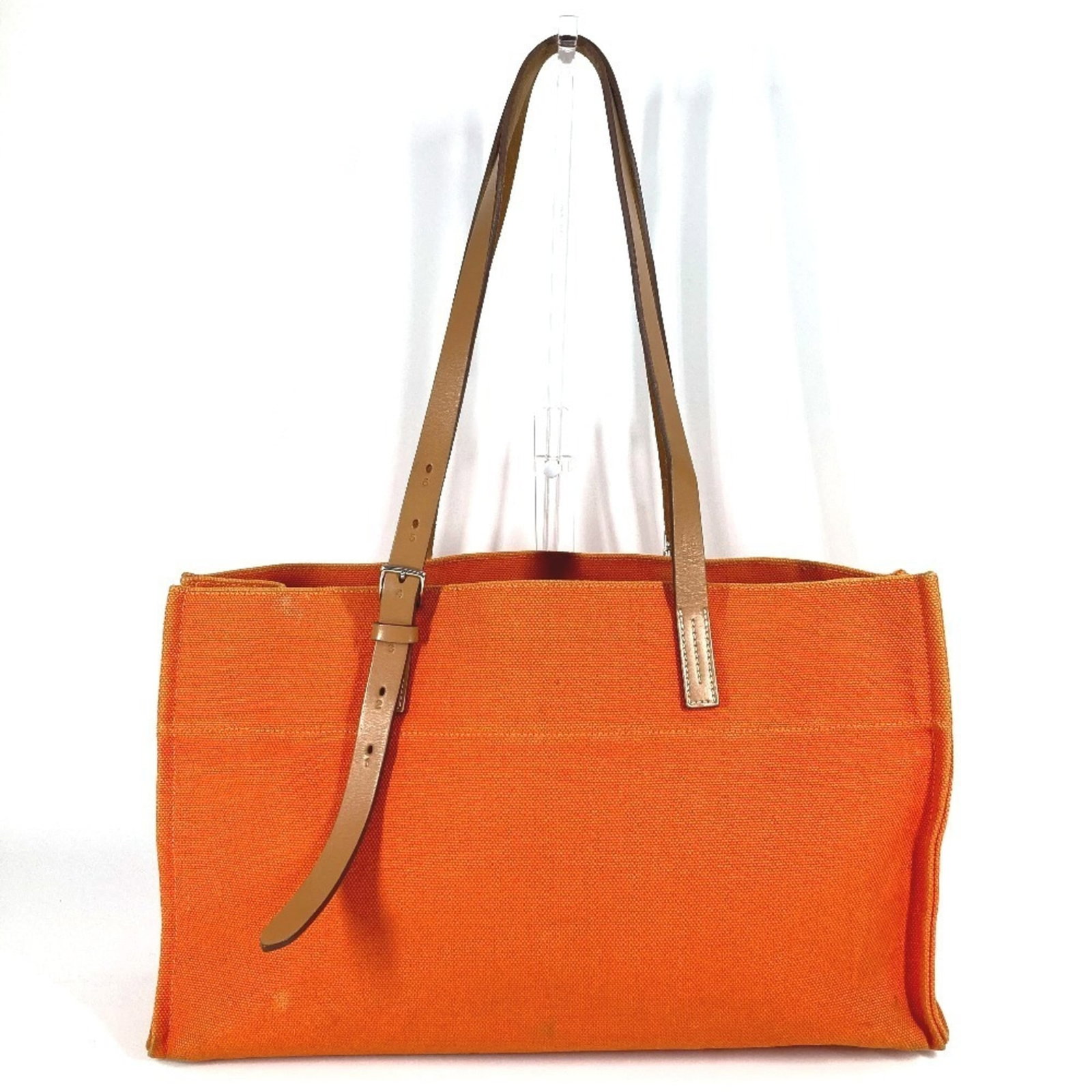 Hermes Shoulder Bag Tote Bag Leather Canvas: Hermes Shoulder Bag Tote Bag Leather Canvas This Herm?s shoulder bag tote features a unique blend of leather and canvas materials in a vibrant orange hue. With its classic design and timeless style, t