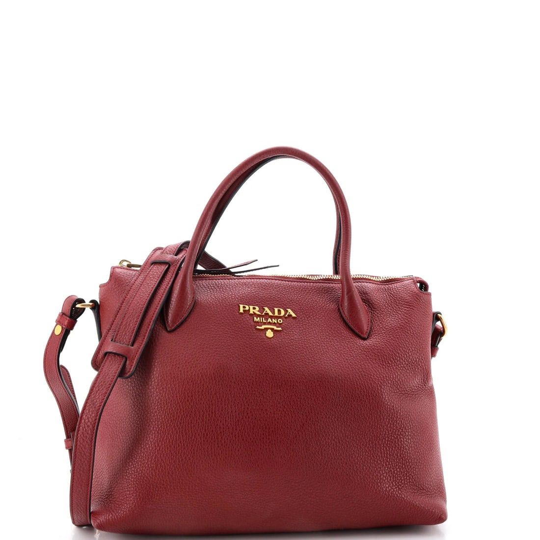 Vitello Daino Prada Medium Dual Strap Zip Tote: Vitello Daino Prada Medium Dual Strap Zip Tote The Vitello Daino Prada Medium Dual Strap Zip Tote boasts a striking red exterior made from high-quality leather, complemented by gold hardware and a bla