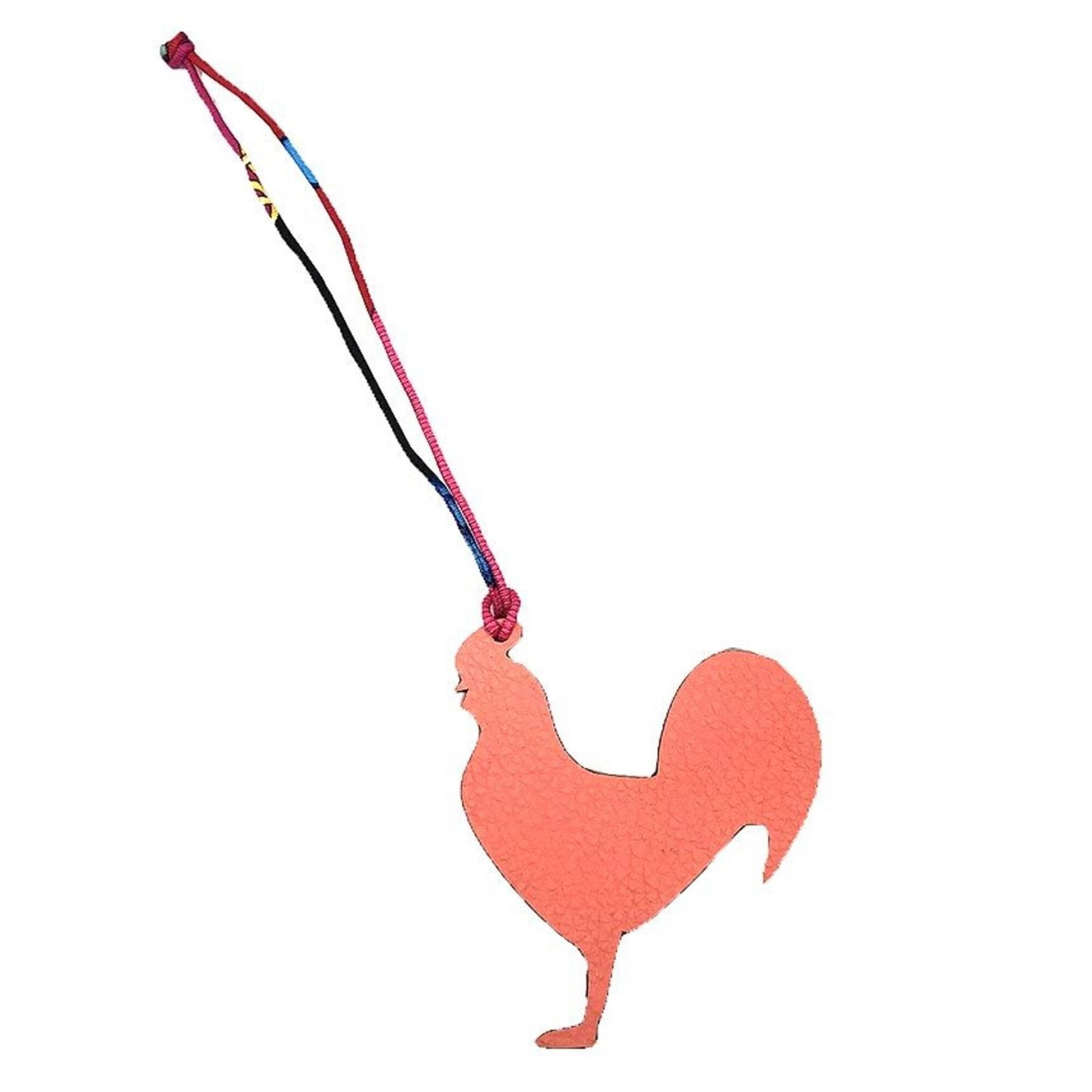 Hermes Handbag Charm Leather: Hermes Handbag Charm Leather The Hermes Handbag Charm Leather is an opened leather charm in pink and red colors. Made from high-quality leather, this charming accessory features a distinctive design t