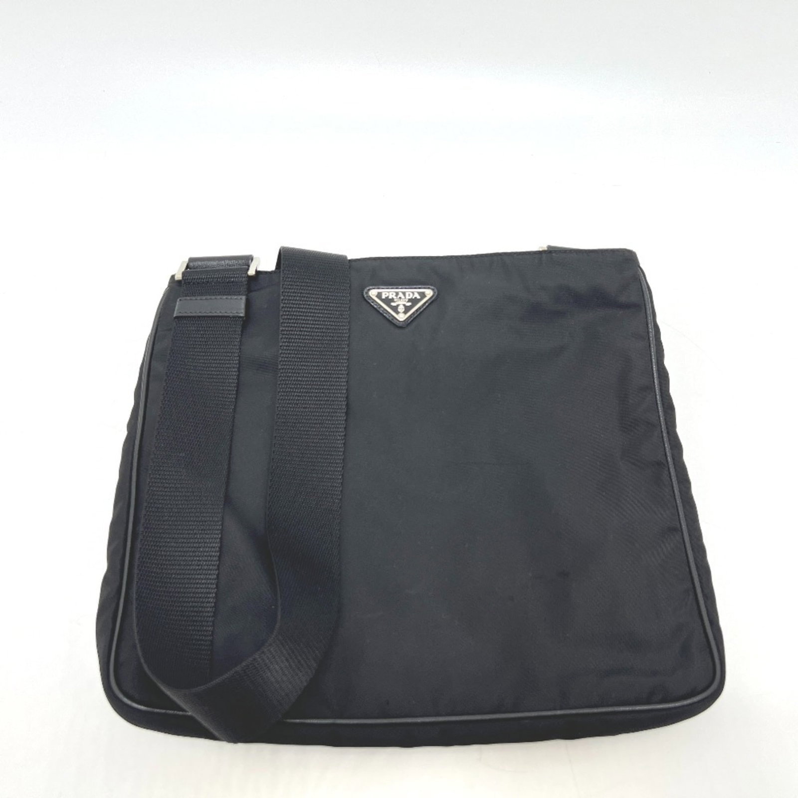 Prada Shoulder Bag Nylon: Prada Shoulder Bag Nylon The Prada Nylon Shoulder Bag boasts sleek black nylon construction and silver hardware for a sophisticated look. With multiple pockets, including a zipper pocket and snap pock