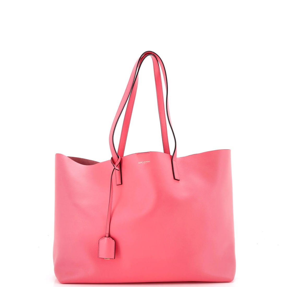 Large leather shopper tote by Saint Laurent: Large leather shopper tote by Saint Laurent Pink leather shopper tote by Saint Laurent features a classic design with a large size and clochette pochette. The exterior has minor creases, cracking, and