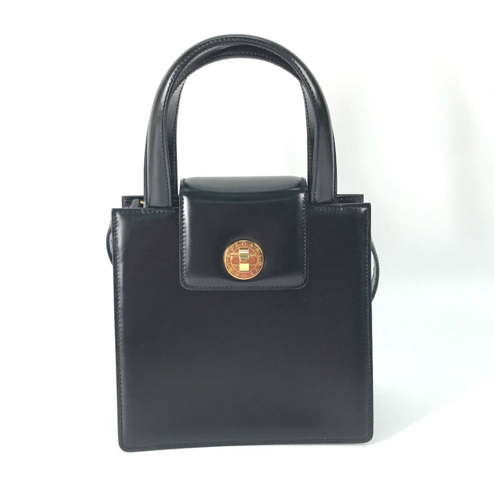 Bvlgari Handbag Leather: Bvlgari Handbag Leather The Bvlgari Handbag Leather is a sleek and sophisticated accessory in black leather, measuring 18.5cm x19.5cm x9.5cm. With its classic design and durable construction, this han