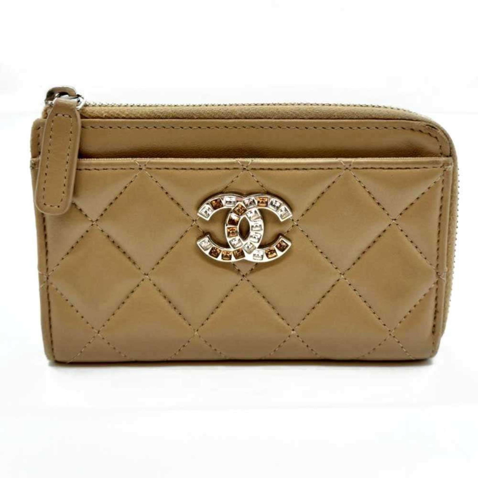 Chanel Pochette Leather: Chanel Pochette Leather Chanel Pochette Leather is a classic accessory featuring lambskin material and a zipper closure. The beige and light brown color options add a touch of sophistication to this