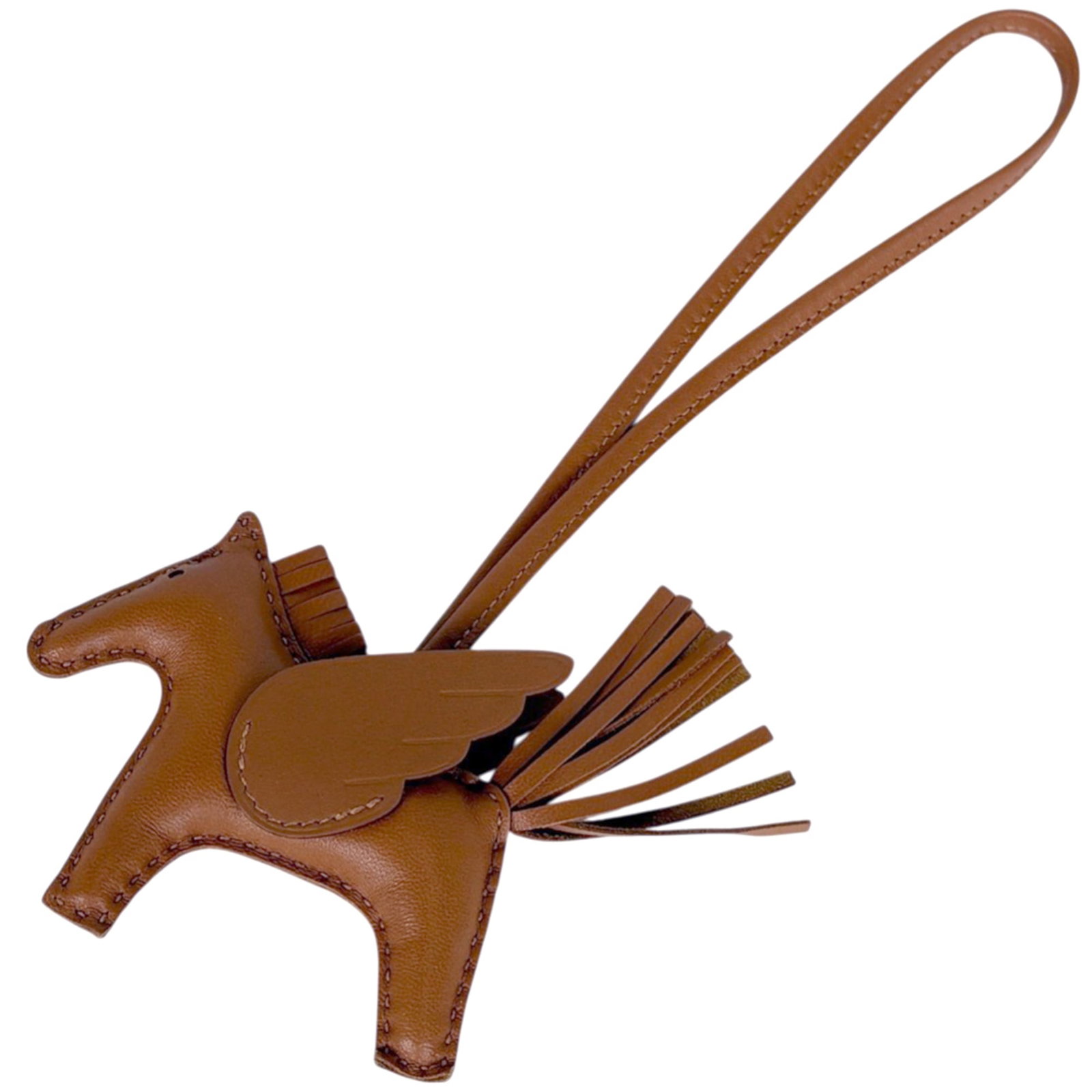 Hermes Handbag Charm Leather: Hermes Handbag Charm Leather Used Hermes Handbag Charm in Brown Leather. This charm features traces of usage and minor scratches/dirt, with overall good condition despite its worn appearance. The leat
