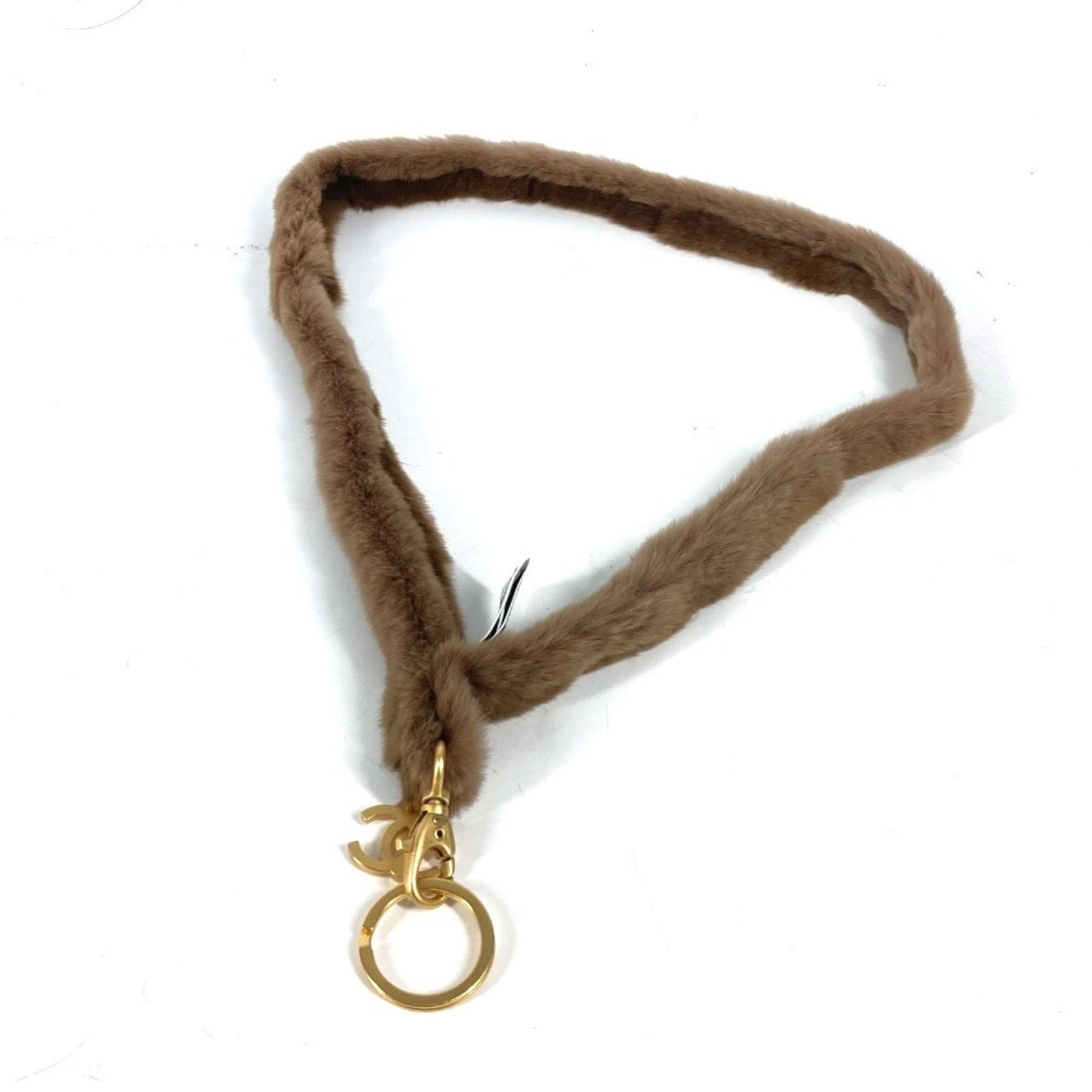 Chanel Neck Strap: Chanel Neck Strap The Chanel Neck Strap features a rich brown and gold color combination, showcasing the brand's iconic style. With only minor signs of wear, such as scratches and dirt, this used piec