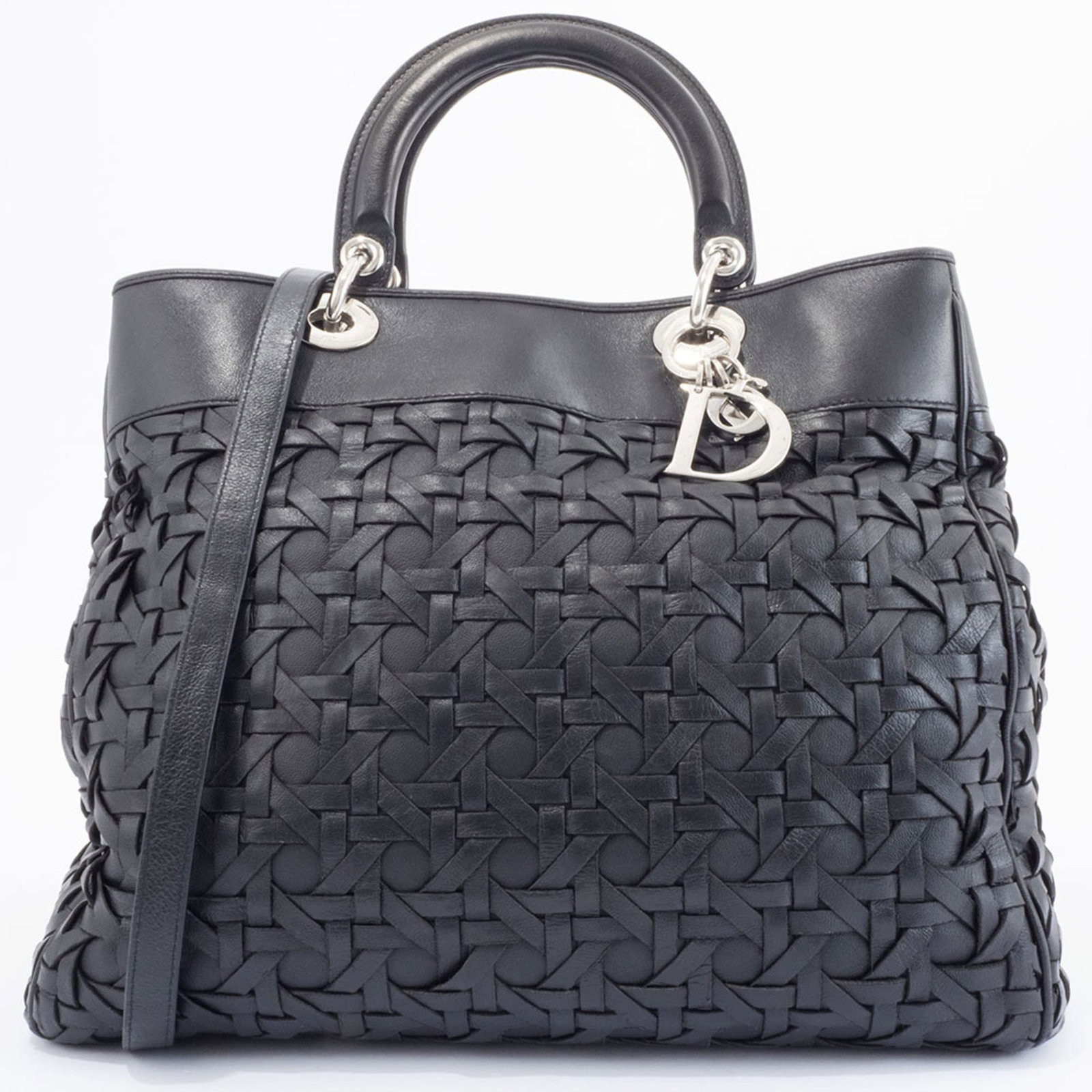 Christian Dior Handbag Leather: Christian Dior Handbag Leather The Christian Dior handbag features high-quality black leather construction with visible traces of usage and minor scratches. Its classic design and timeless style make