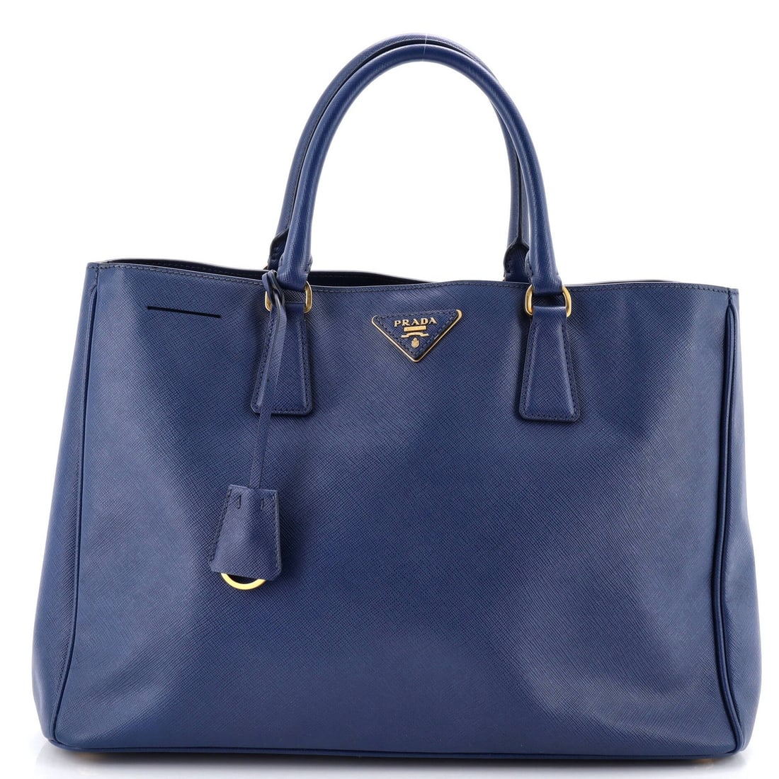 Lux open tote saffiano leather large: Lux open tote saffiano leather large The Prada Lux Open Tote Saffiano Leather Large boasts a striking blue exterior with heavy creases throughout and edge wear. This spacious tote features gold