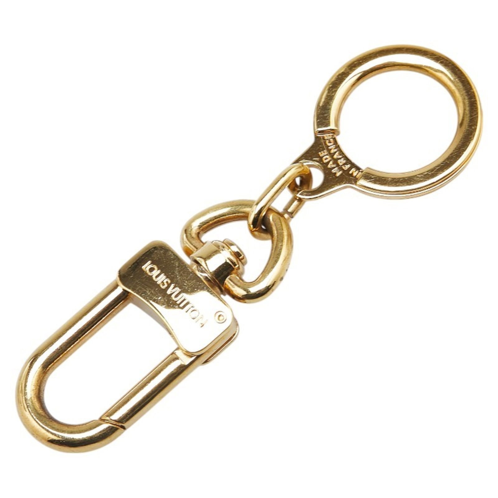 Louis Vuitton Keyring: Louis Vuitton Keyring This Louis Vuitton keyring boasts a sleek gold finish and measures 8cm in length, making it a stylish accessory for everyday use. With some minor signs of wear, such as scratches