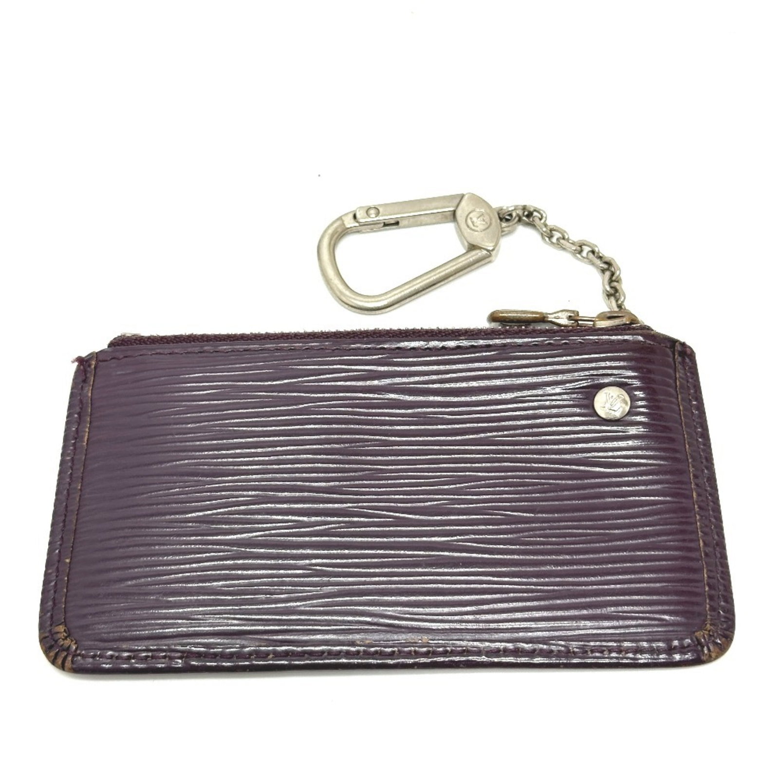 Louis Vuitton Keycase Epi Leather: Louis Vuitton Keycase Epi Leather The Louis Vuitton Keycase Epi Leather features a classic design with Cassis color and Epi leather material. It has been used and shows traces of usage, with some dama