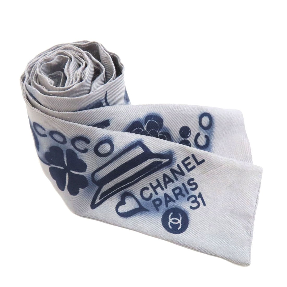 Coco Chanel Mark Silky Scarf: Coco Chanel Mark Silky Scarf Coco Chanel Mark Silky Scarf in gray silk features a classic design. This scarf showcases the iconic mark of the renowned fashion brand CHANEL. Made from high-quality silk