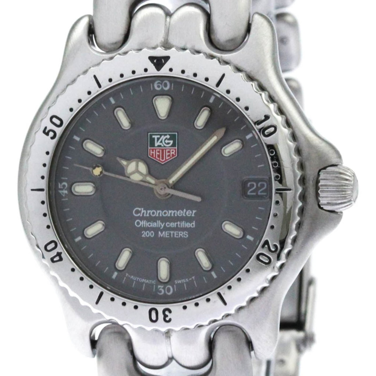 Heuer Watch Tag: Heuer Watch Tag Stainless steel case and band provide a sleek, modern look for this 34mm gray Heuer watch. A few traces of usage are visible, with some minor scratches and dirt, but overall the