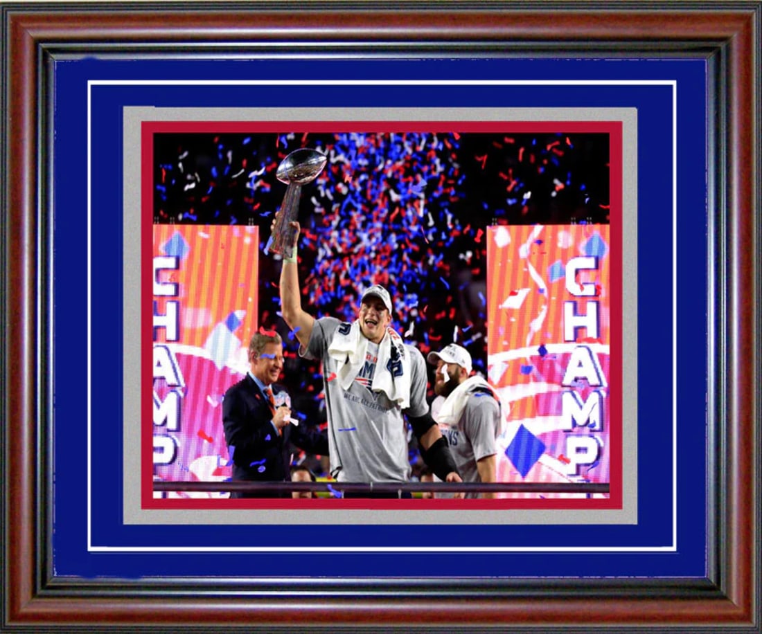Super Bowl XLIX Celebration Framed Photo: Super Bowl XLIX Celebration Framed Photo A beautifully framed 8x10 photo of Rob Gronkowski holding up the Super Bowl XLIX Trophy for the New England Patriots. The cherry wood frame with blue on