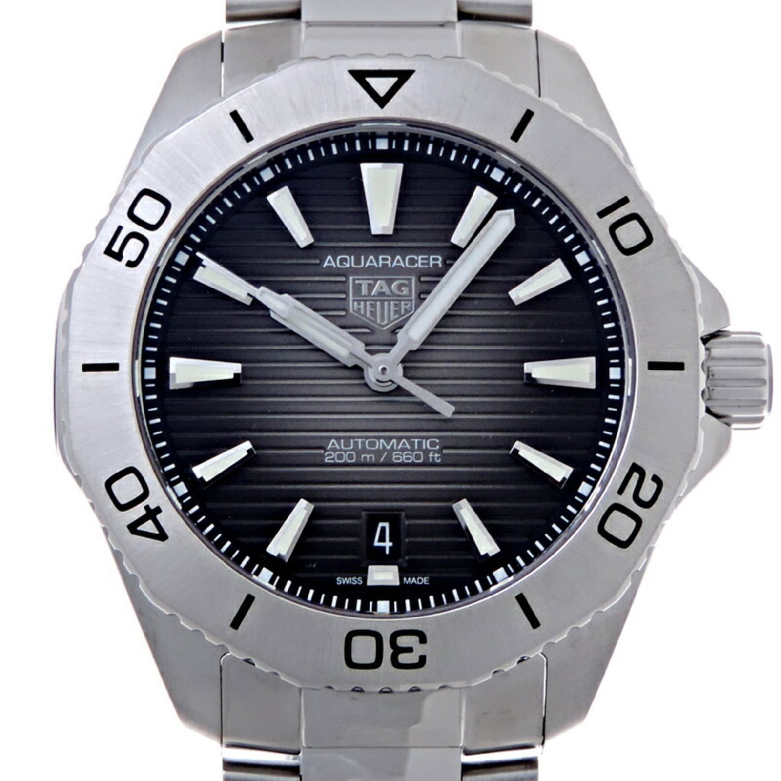 Heuer Watch Tag: Heuer Watch Tag Stainless steel case and band provide a sleek, durable foundation for this black dial watch. Traces of usage are visible, with scratches and dirt present, but overall in good