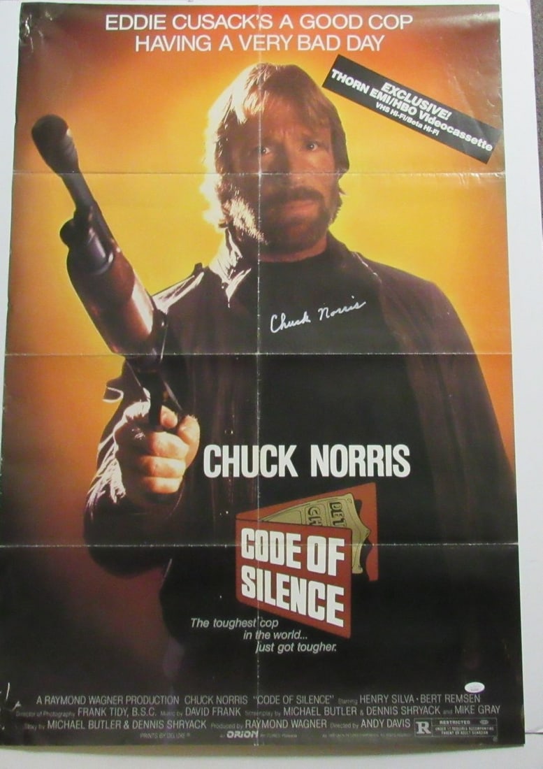 Chuck Norris Autographed Code of Silence 27x40 Poster: Chuck Norris Autographed Code of Silence 27x40 Poster This original Chuck Norris autographed Code of Silence 27x40 poster showcases the iconic actor's distinctive style. Brought to you in its authenti