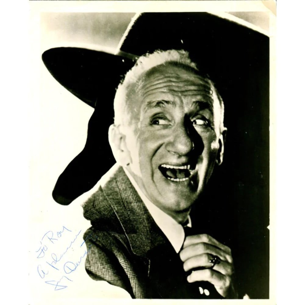 Durante Jimmy Signed Photo With: Durante Jimmy Signed Photo With Jimmy Durante's charismatic smile and wit are captured in this signed photo, accompanied by an autographed envelope for added authenticity. The item is presented in