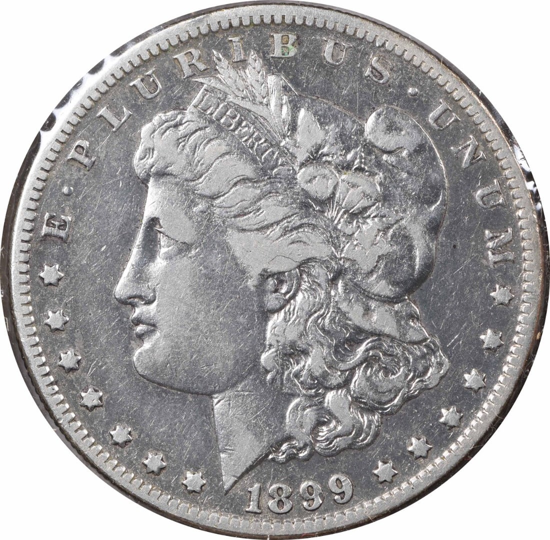 Morgan Silver Dollar VF Uncertified Micro O Vam 1899: Morgan Silver Dollar VF Uncertified Micro O Vam 1899 The 1899 Morgan Silver Dollar is a highly detailed and intricately designed coin, featuring George T. Morgan's iconic design. With its reeded edge 