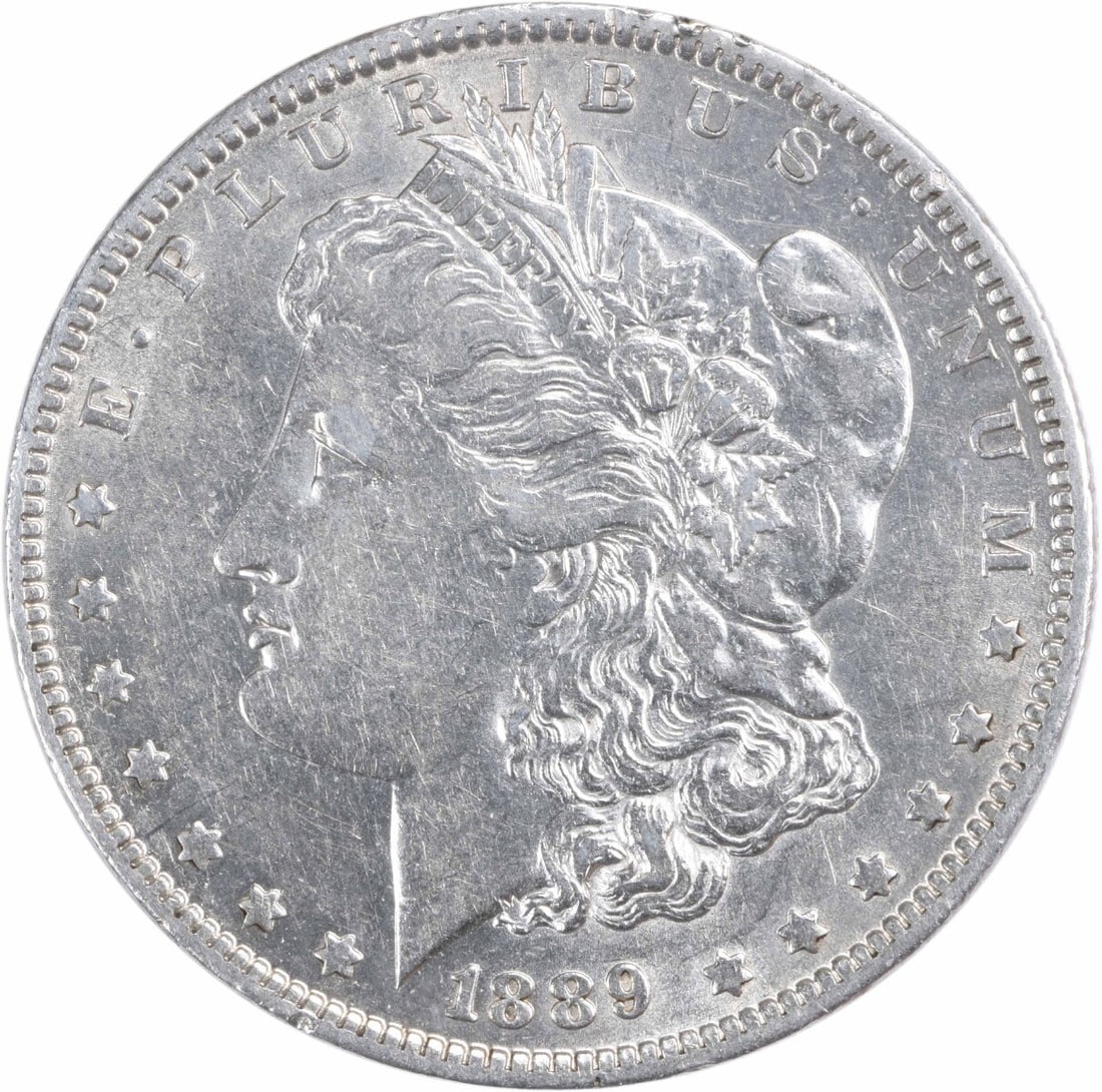 Uncertified AU 1889 MORGAN SILVER DOLLAR: Uncertified AU 1889 MORGAN SILVER DOLLAR The 1889 Morgan Silver Dollar from New Orleans boasts its distinctive reeded edge and circulating condition, offering a unique glimpse into the coin's
